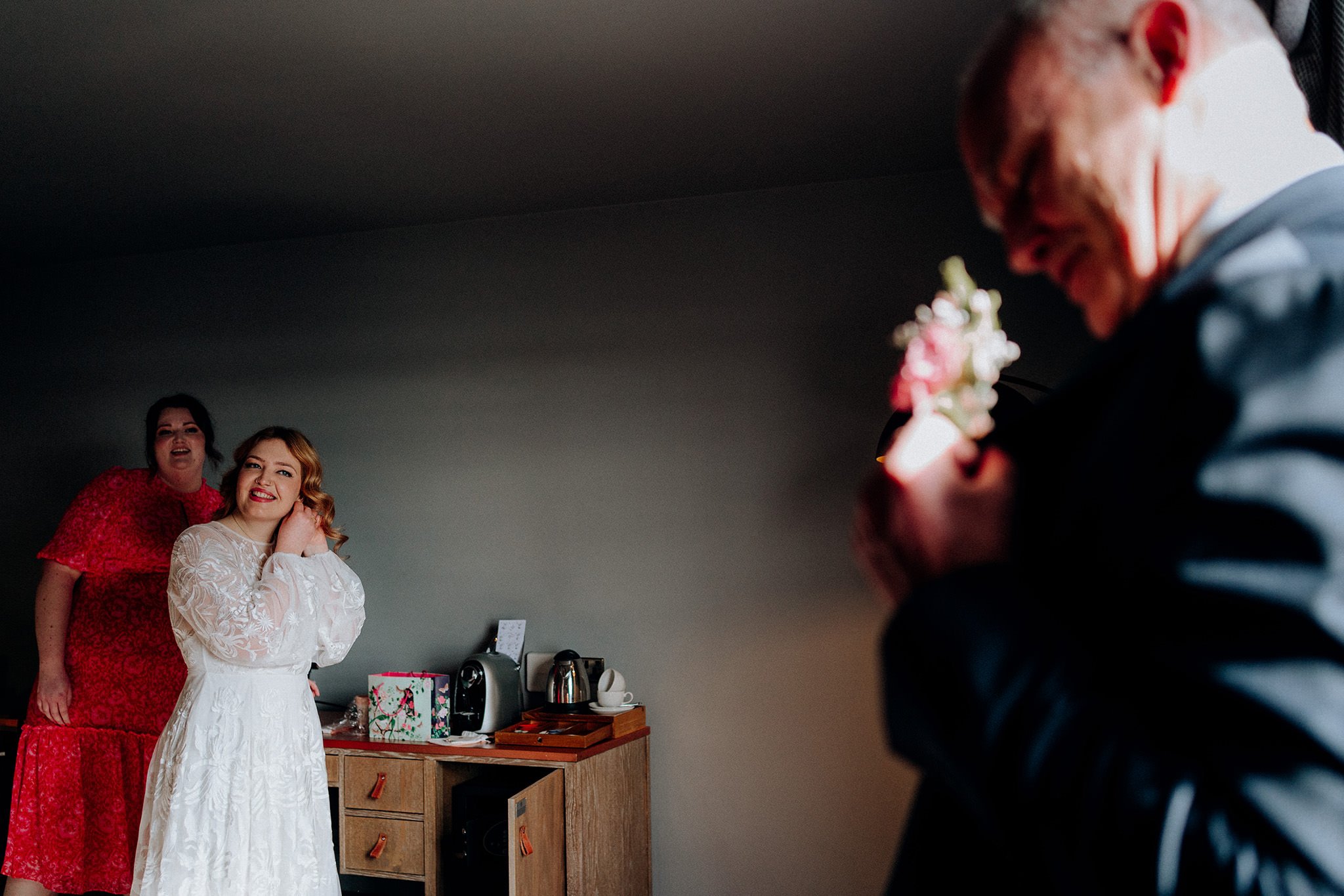 Daughter watching her dad fit flower on her wedding day