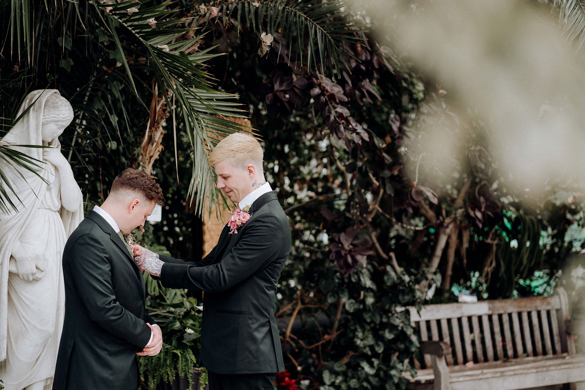 Groom helping his best man with his flower