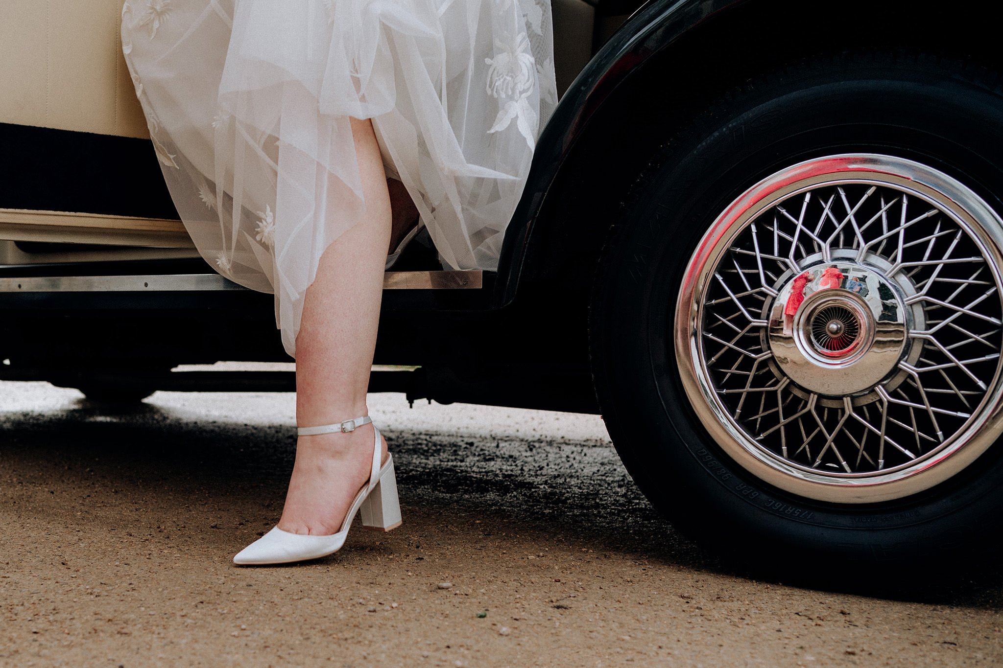 Bride stepping out of the car on her wedding day