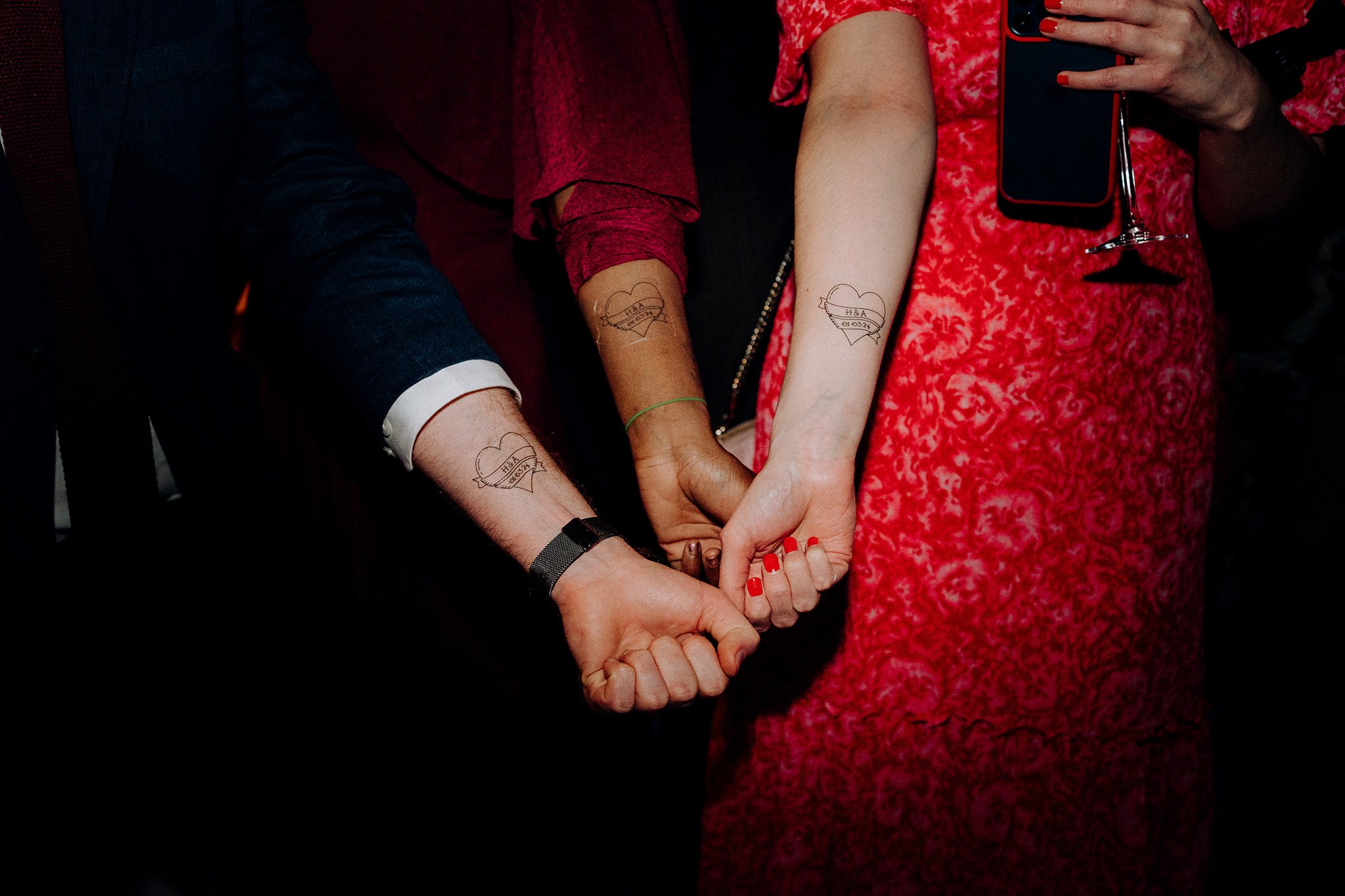 Instant tattoos being worn by guests, which were made by the groom