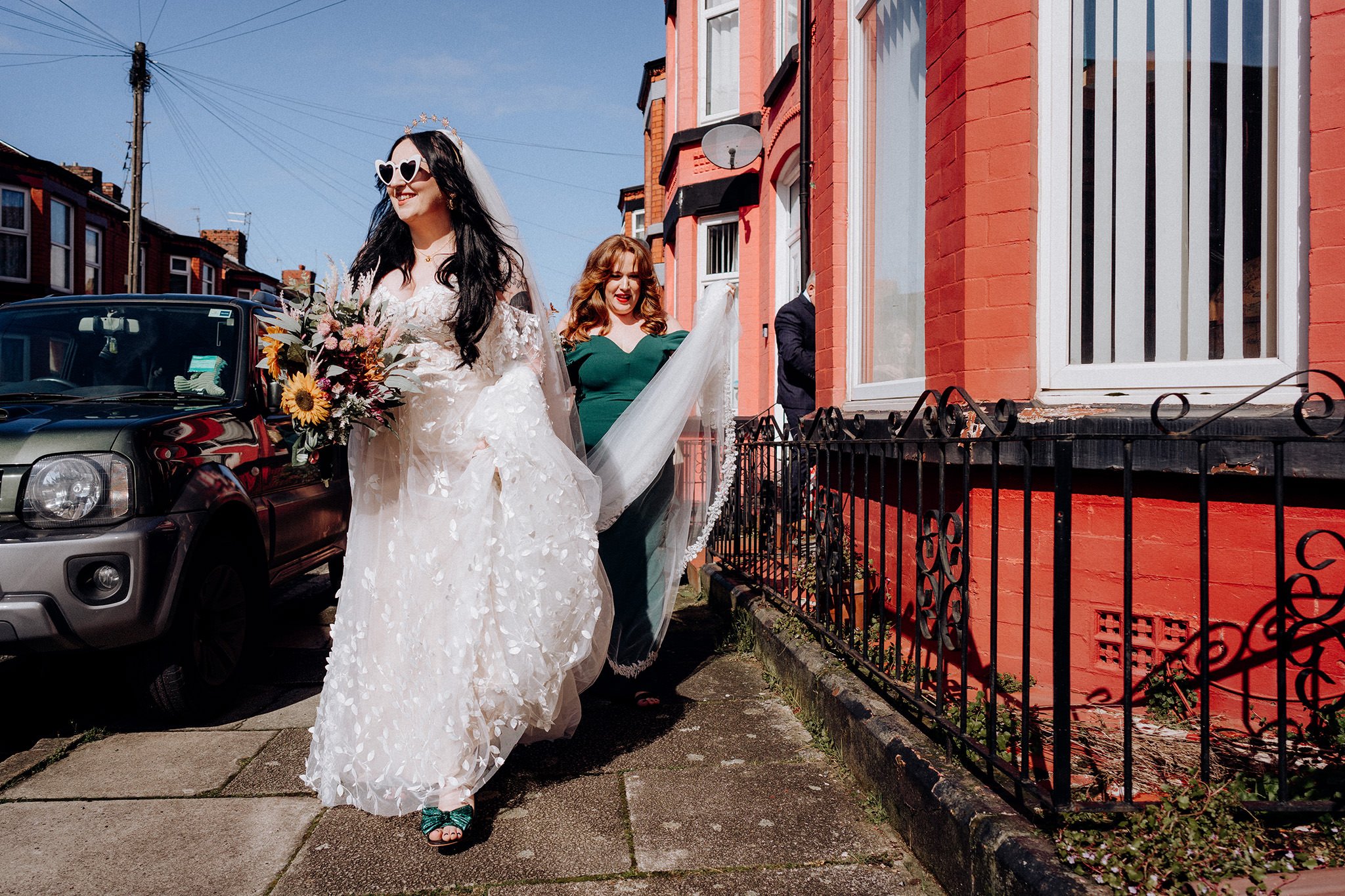 Bride walking down her street in Liverpool