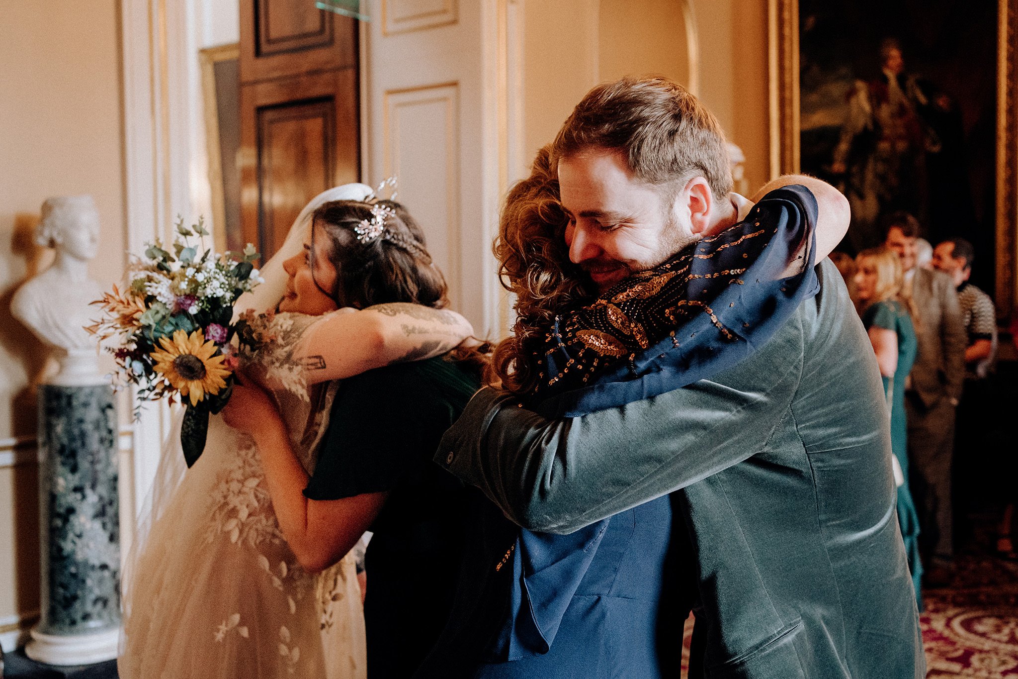 Bride and groom hugging guests at Liverpool Town Hall