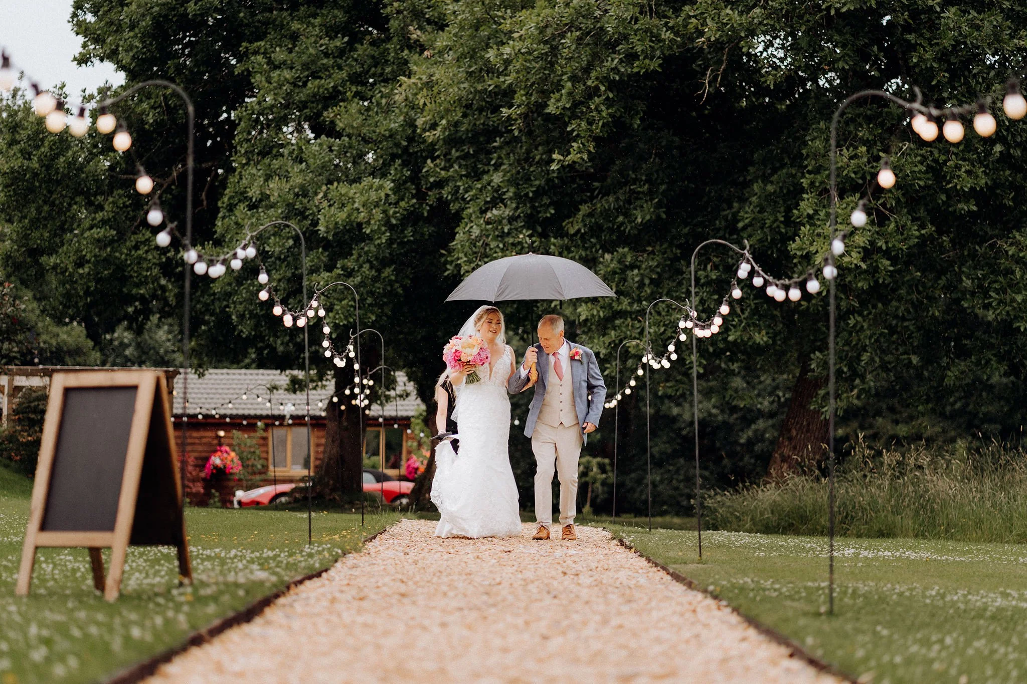 bride and her father walking up the path at tipis at riley green