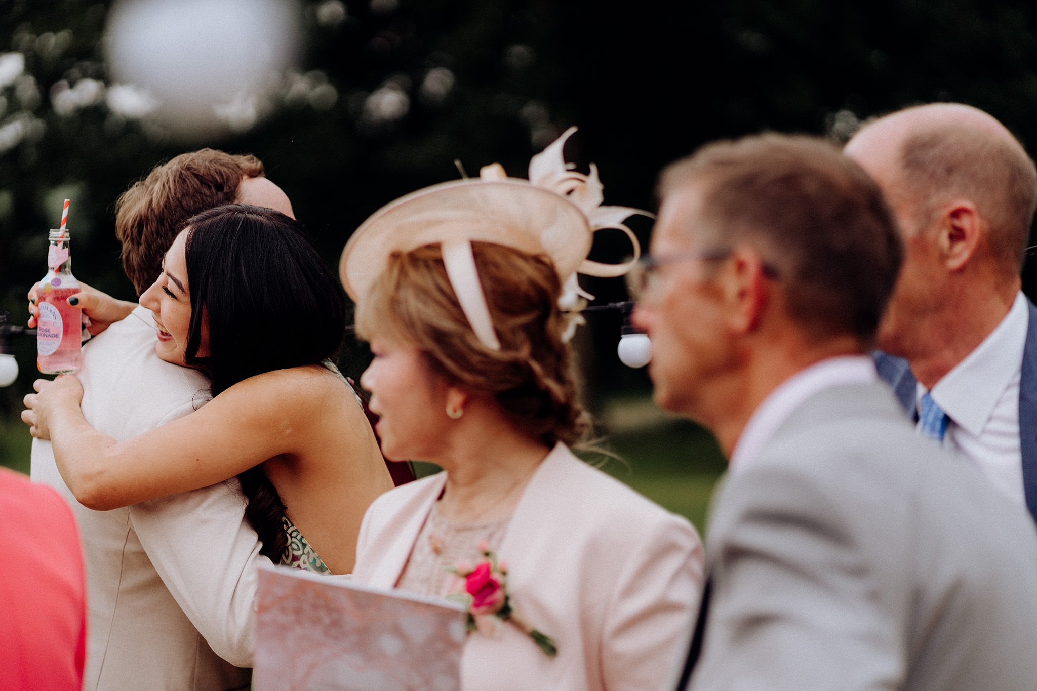 guests hugging at tipis at riley green