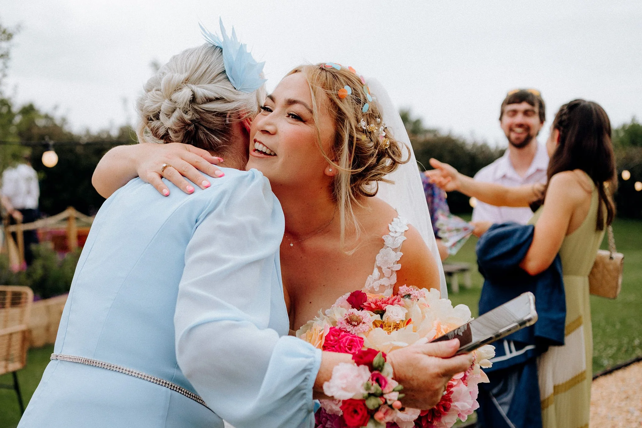 bride hugging groom's mum tipis at riley green