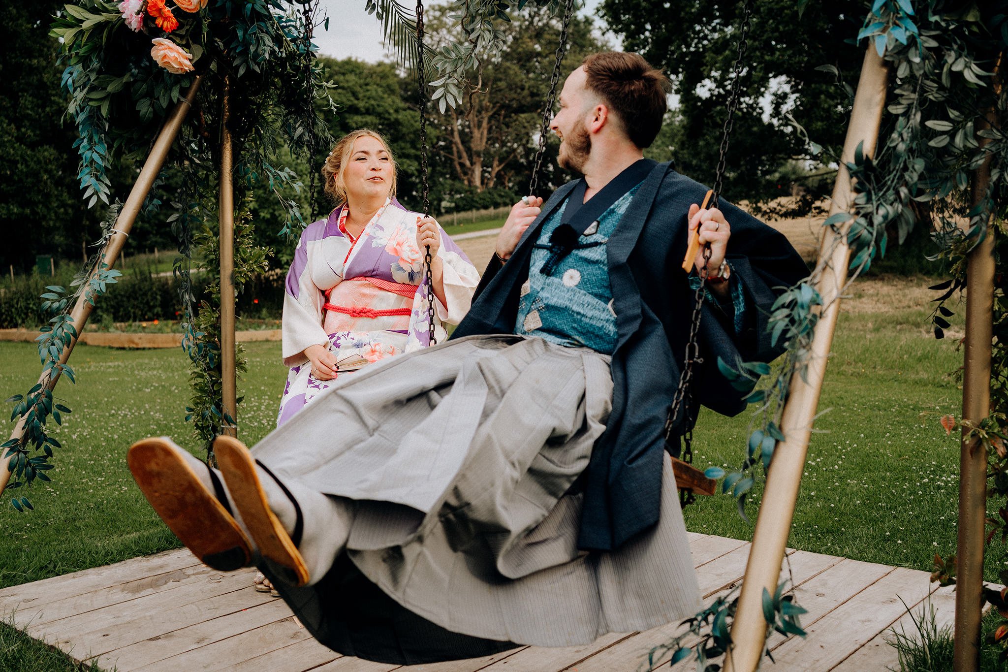 bride and groom on the swing at tipis at riley green