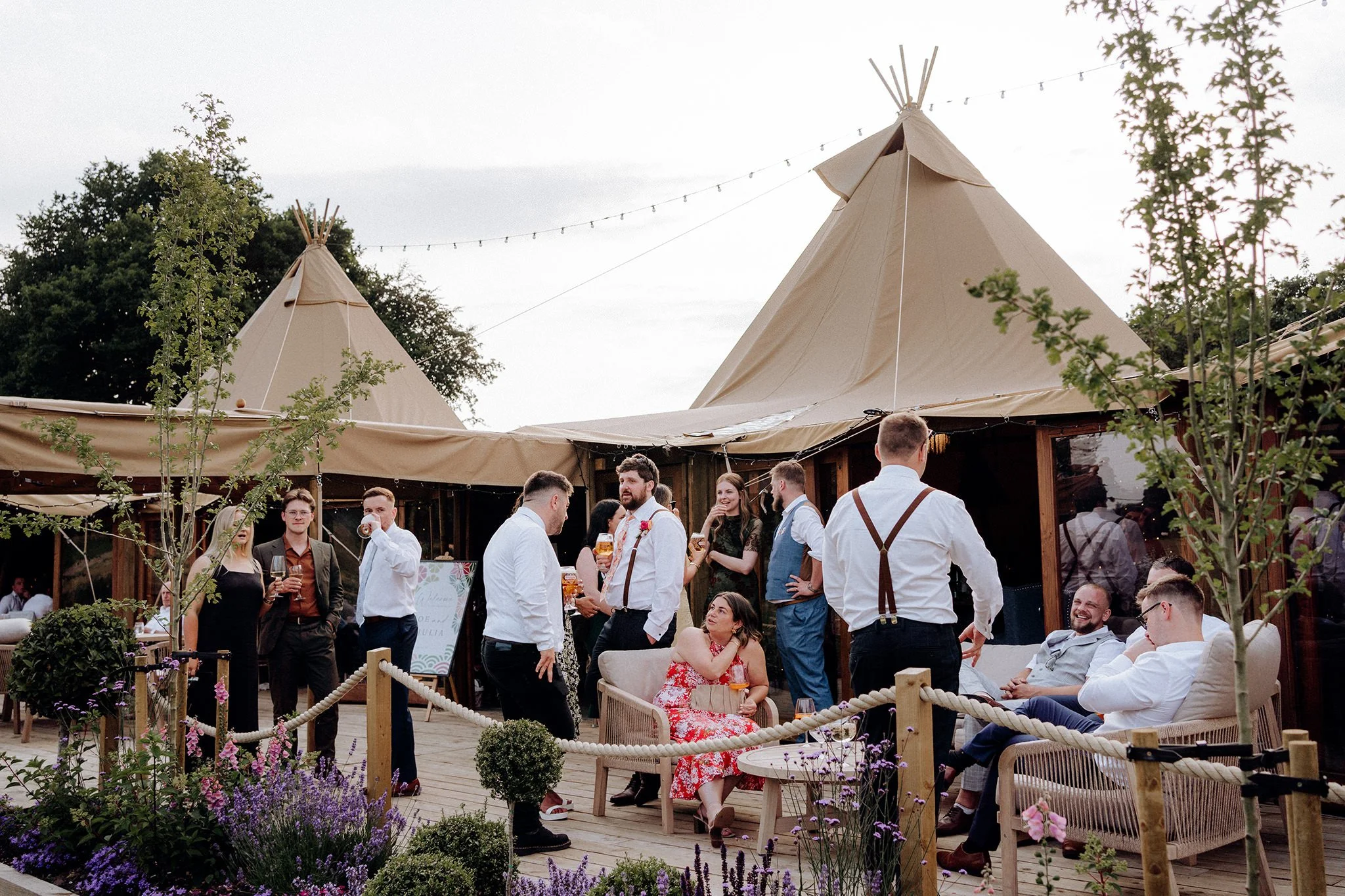 guests relaxing on decking at tipis at riley green