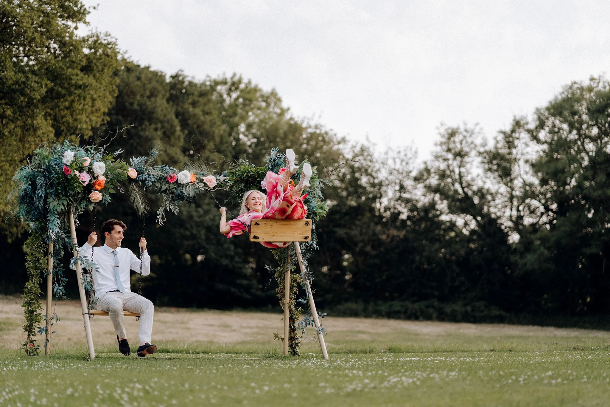 wedding guests playing on the swing