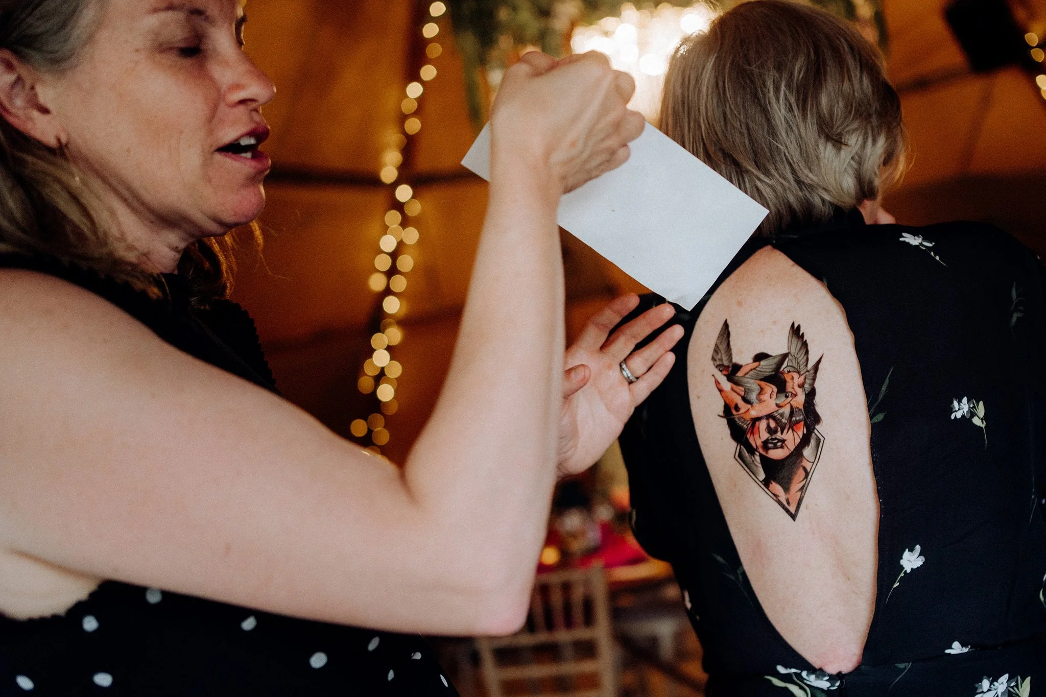 tattoo on the back of a wedding guest