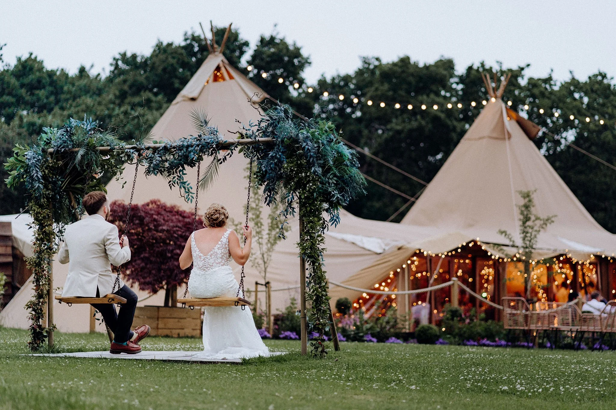 bride and groom enjoying a quiet swing at tipis at riley green