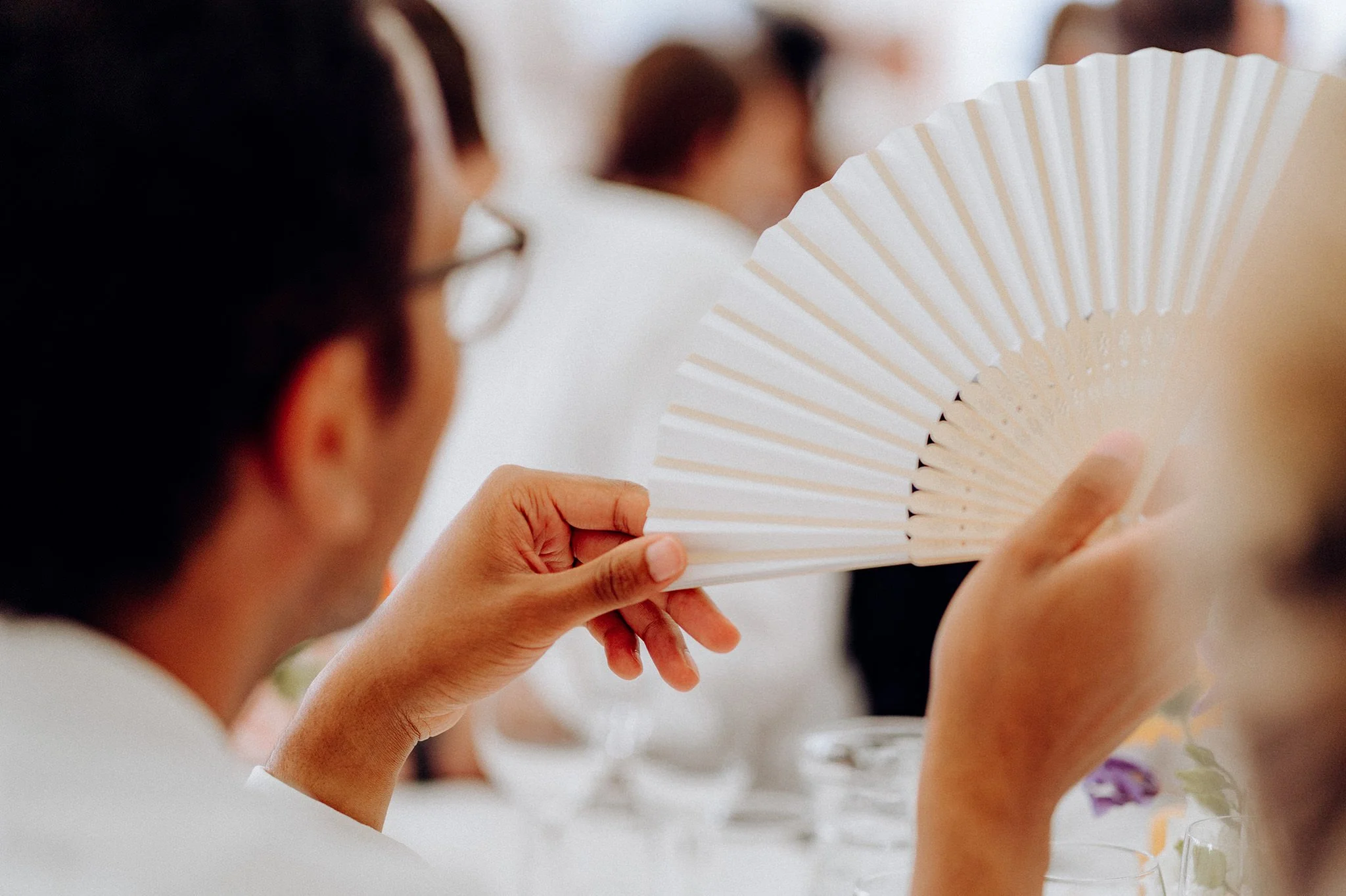 guest fanning themselves marquee wedding