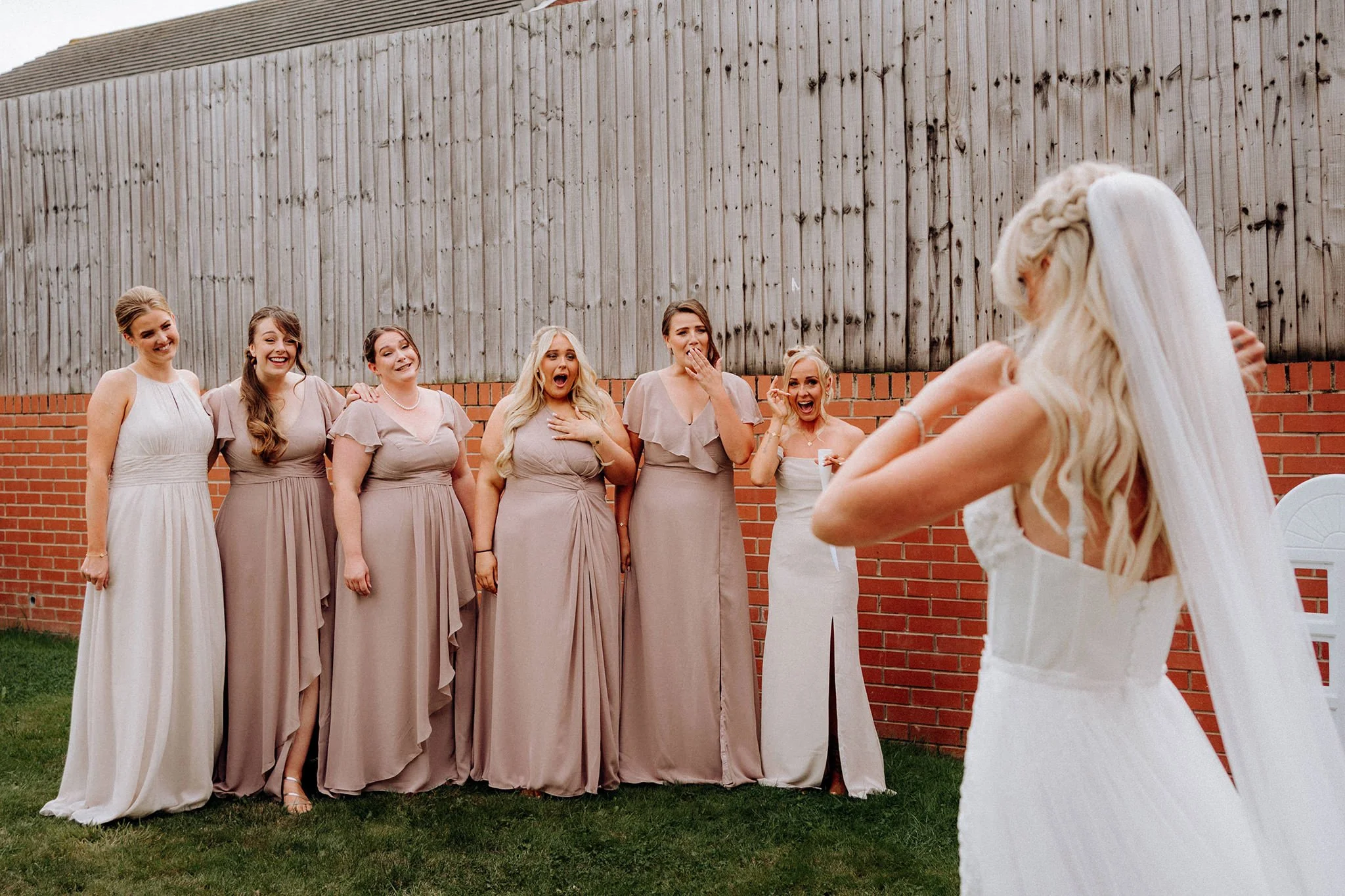 bridal party reacting to seeing bride's dress in wallasey