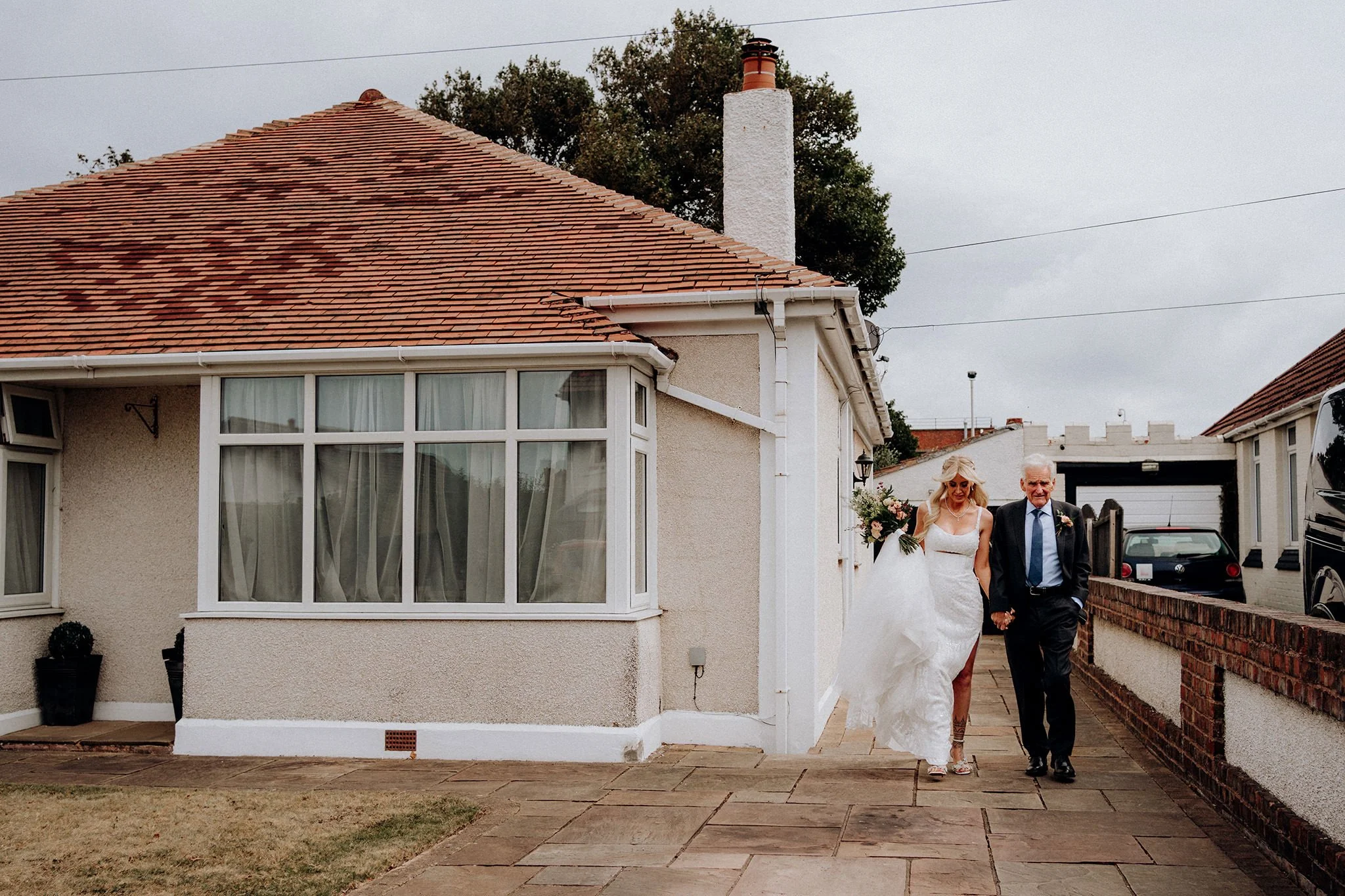 bride and grandad walk to church wallasey