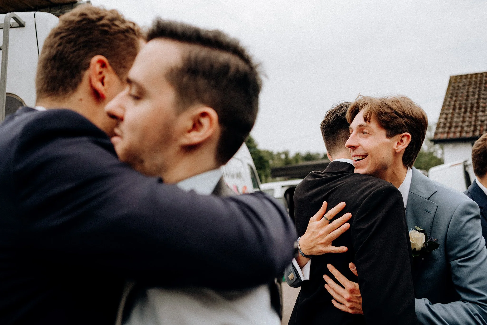 guests hugging and greeting village hall wedding 