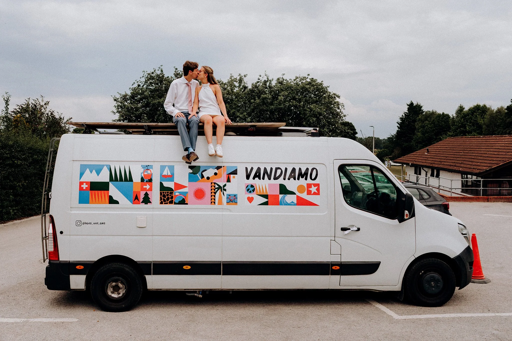 bride and groom kiss on top of van village hall wedding