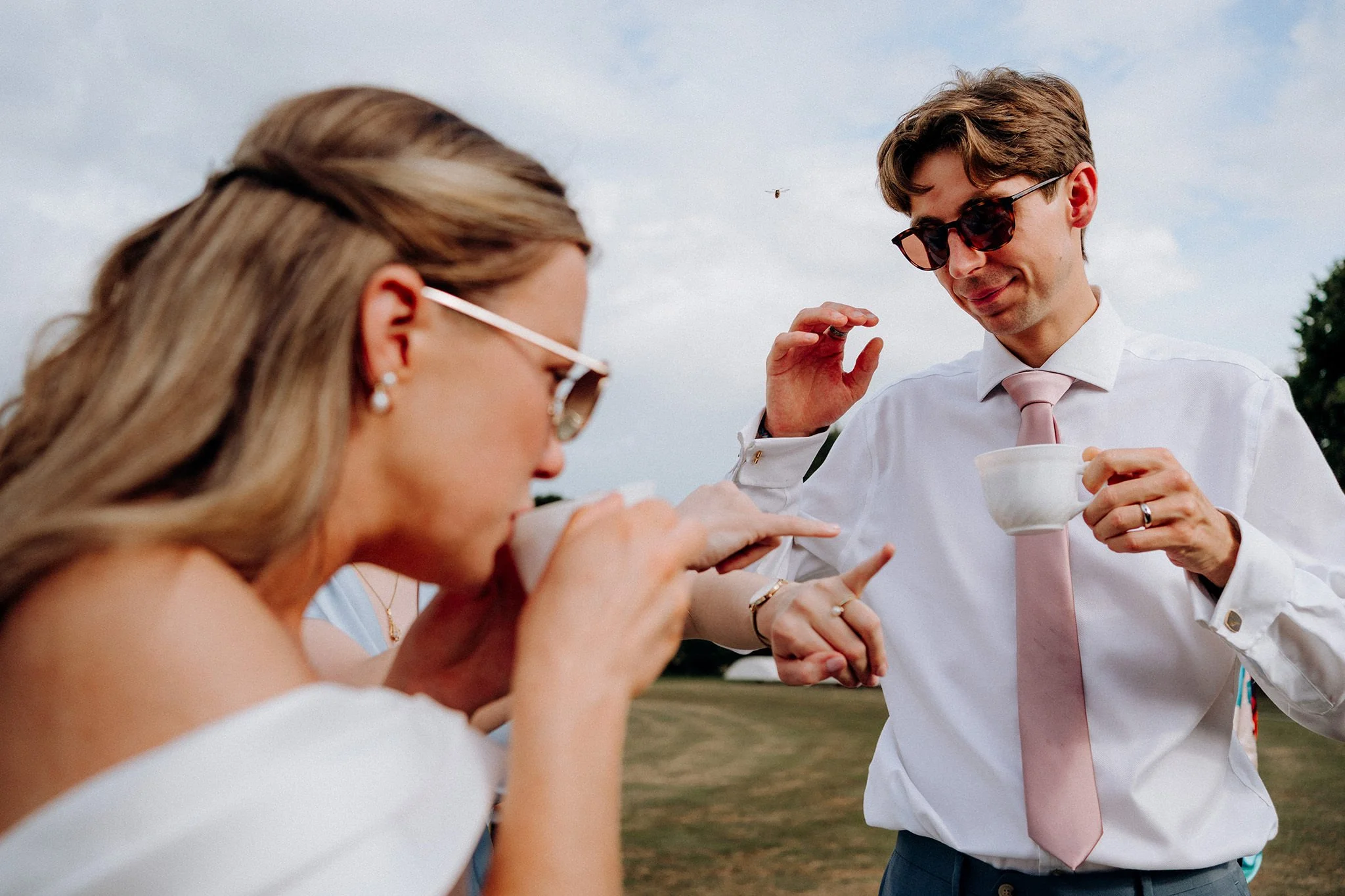 groom pushes a wasp away