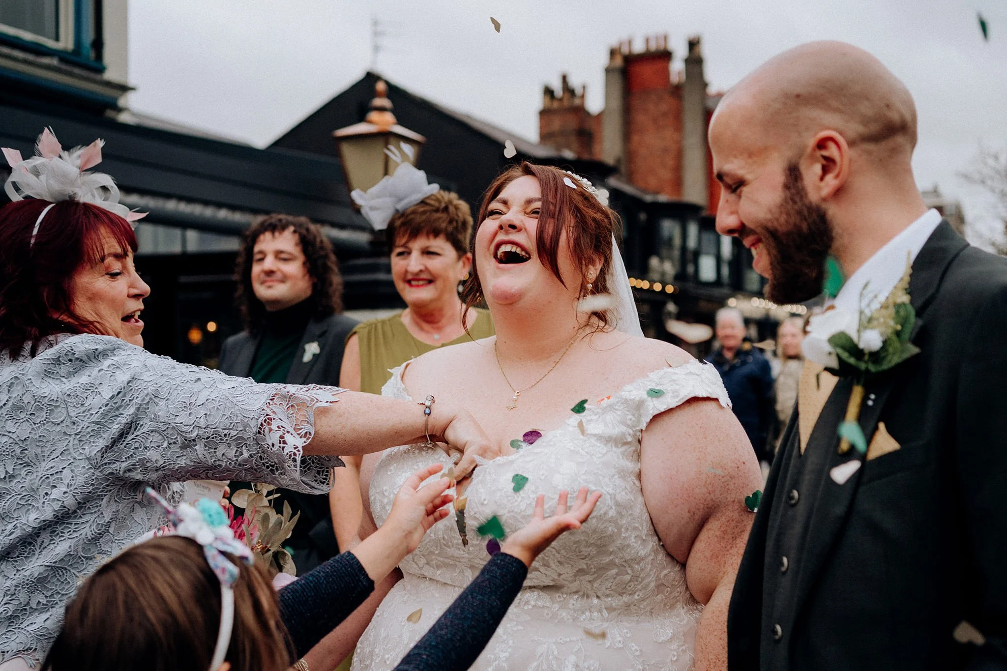 grabbing confetti down brides dress