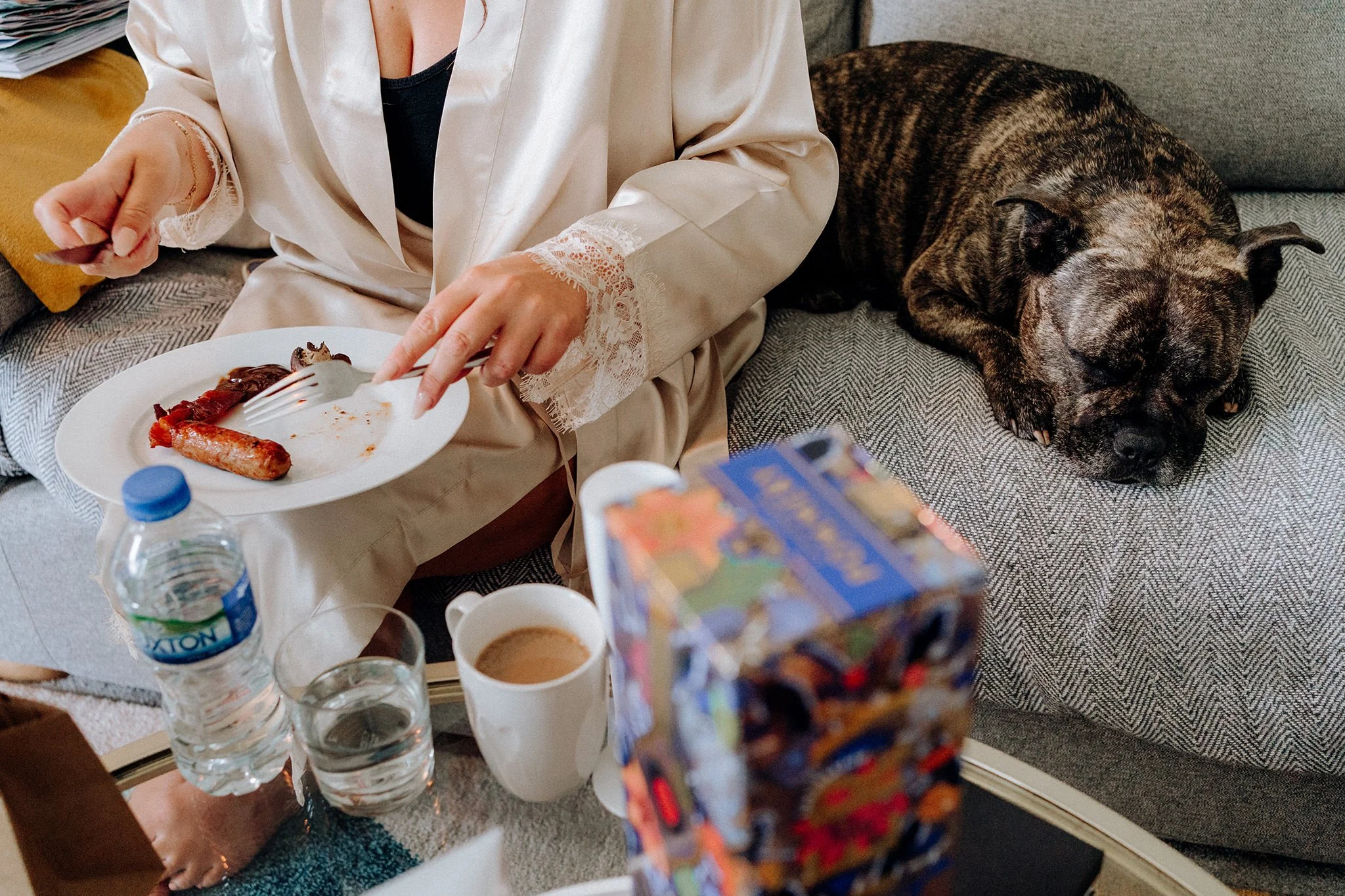 dog sleeps near bridesmaid eating her breakfast