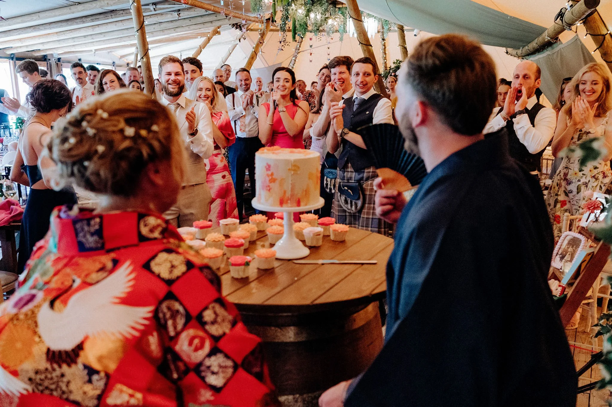 guests reacting to seeing bride and groom arrival in kiminos