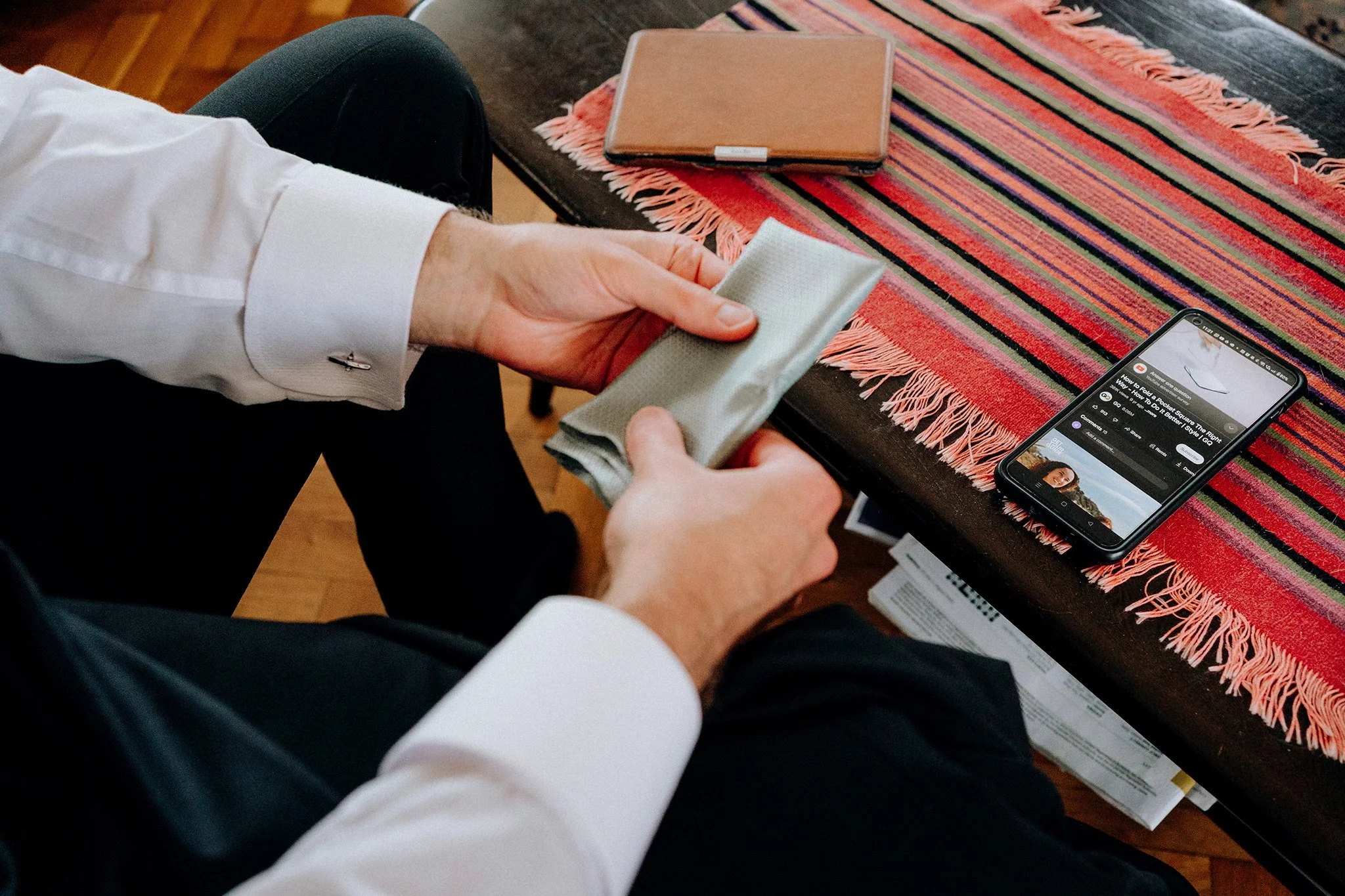 watching a youtube video to show how to fold a pocket square