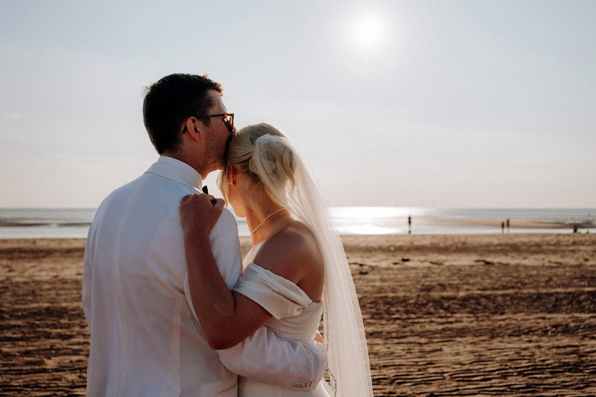bride and groom on their wedding day at crosby beach