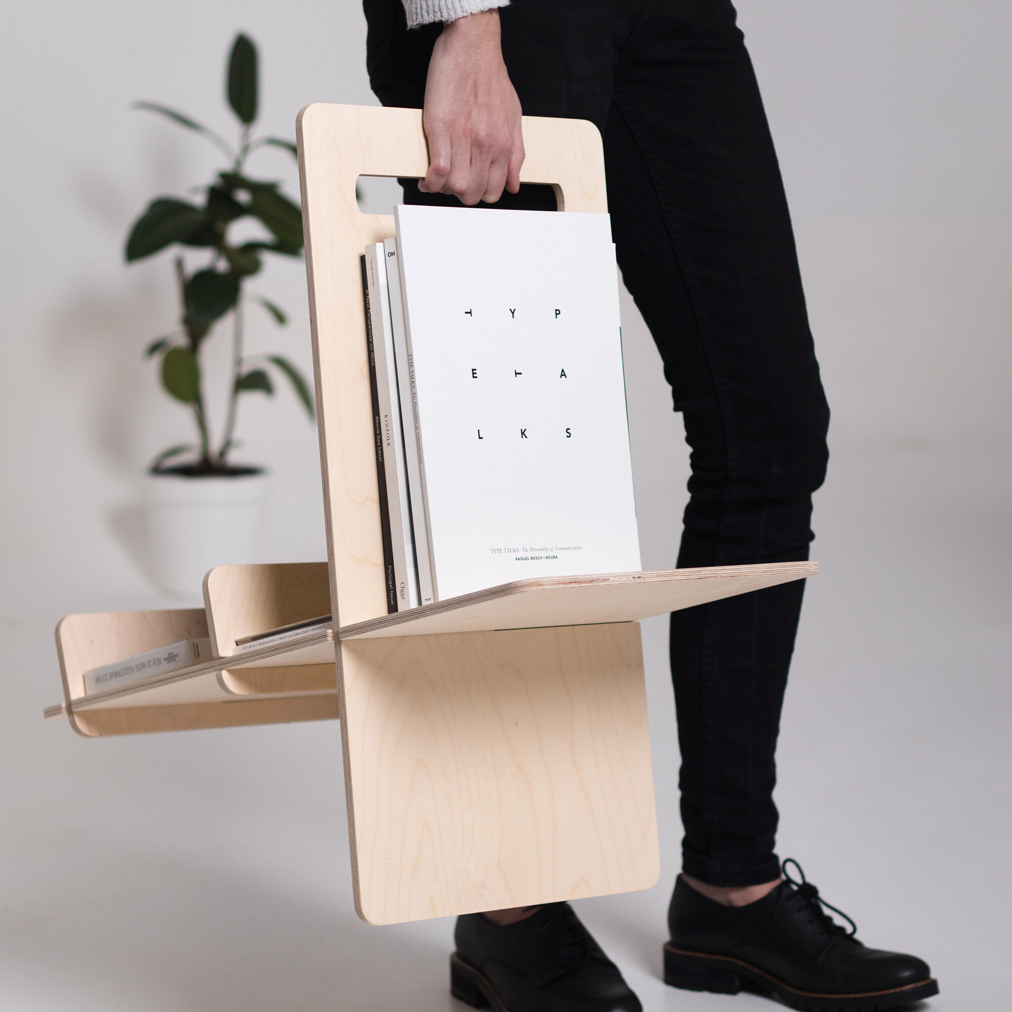 Versatile magazine rack with handle for books and magazines.