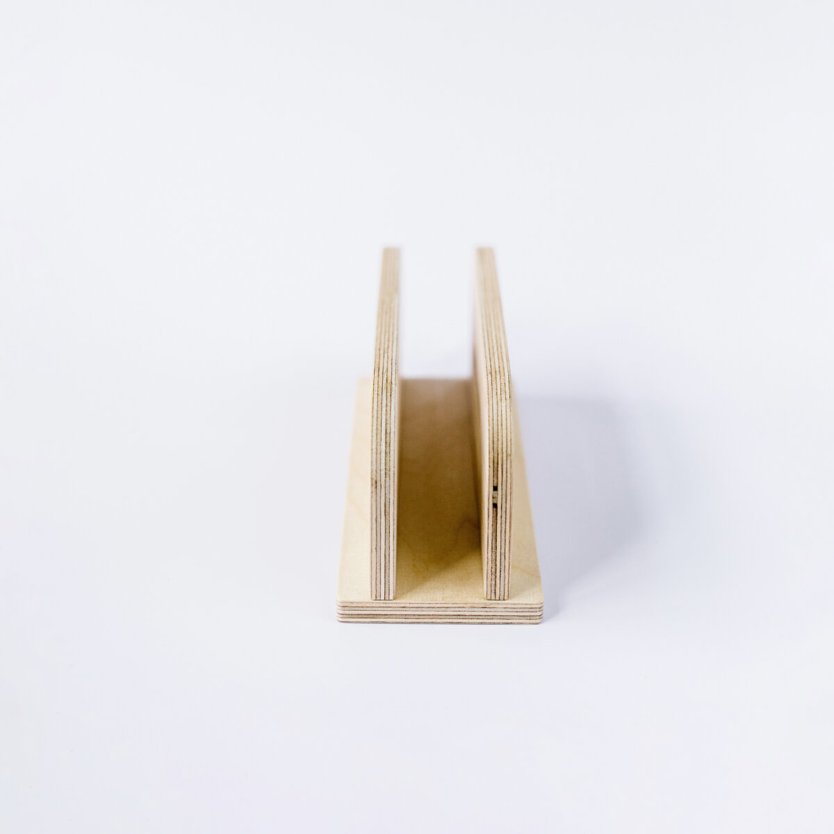DEREST: Vertical laptop stand, charges while stored.