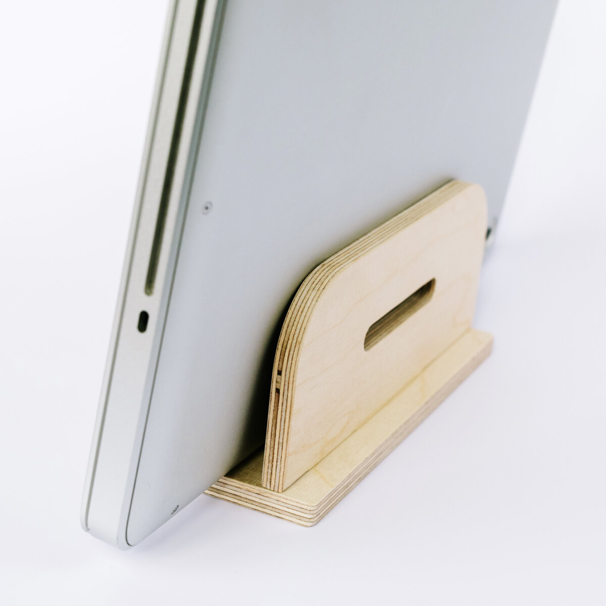 DEREST: Vertical laptop stand, charges while stored.