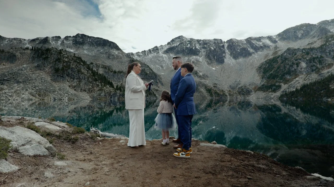 A couple getting married on the mountains with their kids, captured by Vancouver Wedding Videographer Grey House Visual