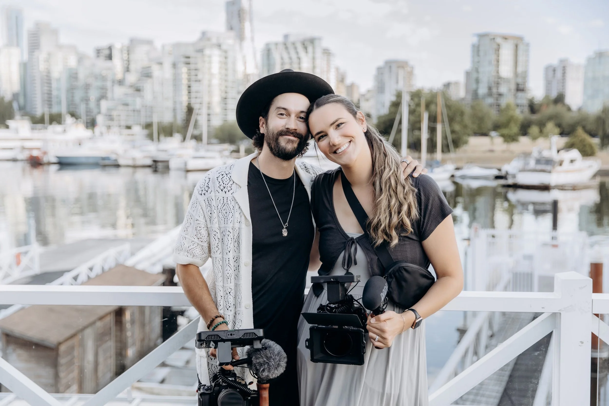 Husband and Wife Vancouver Wedding Videographer Duo Grey House Visual posing for a photo while working