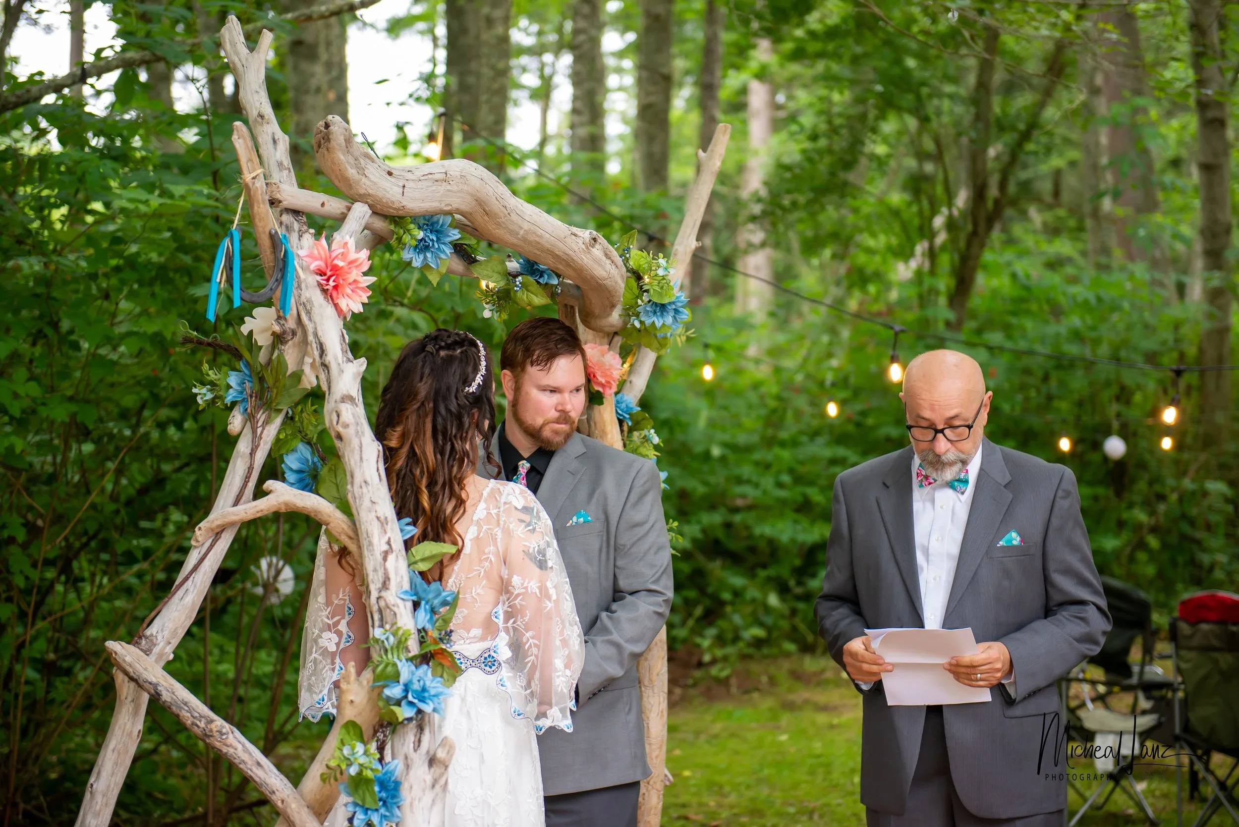 Bride and groom with officiant.