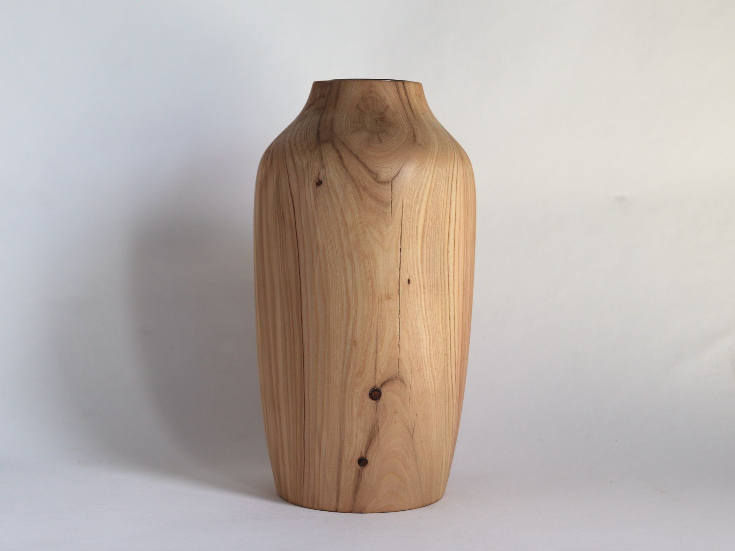 Sustainable reclaimed wood vase with elegant urn shape and removable glass insert for fresh flowers
