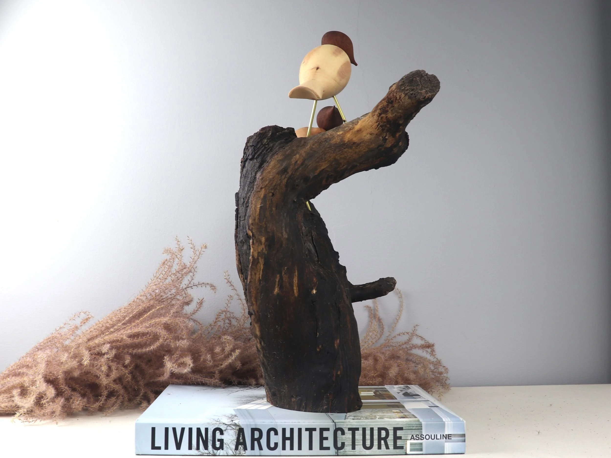 Birds in Love sculpture left side angle showing hand-carved bird tails and contrasting wood tones