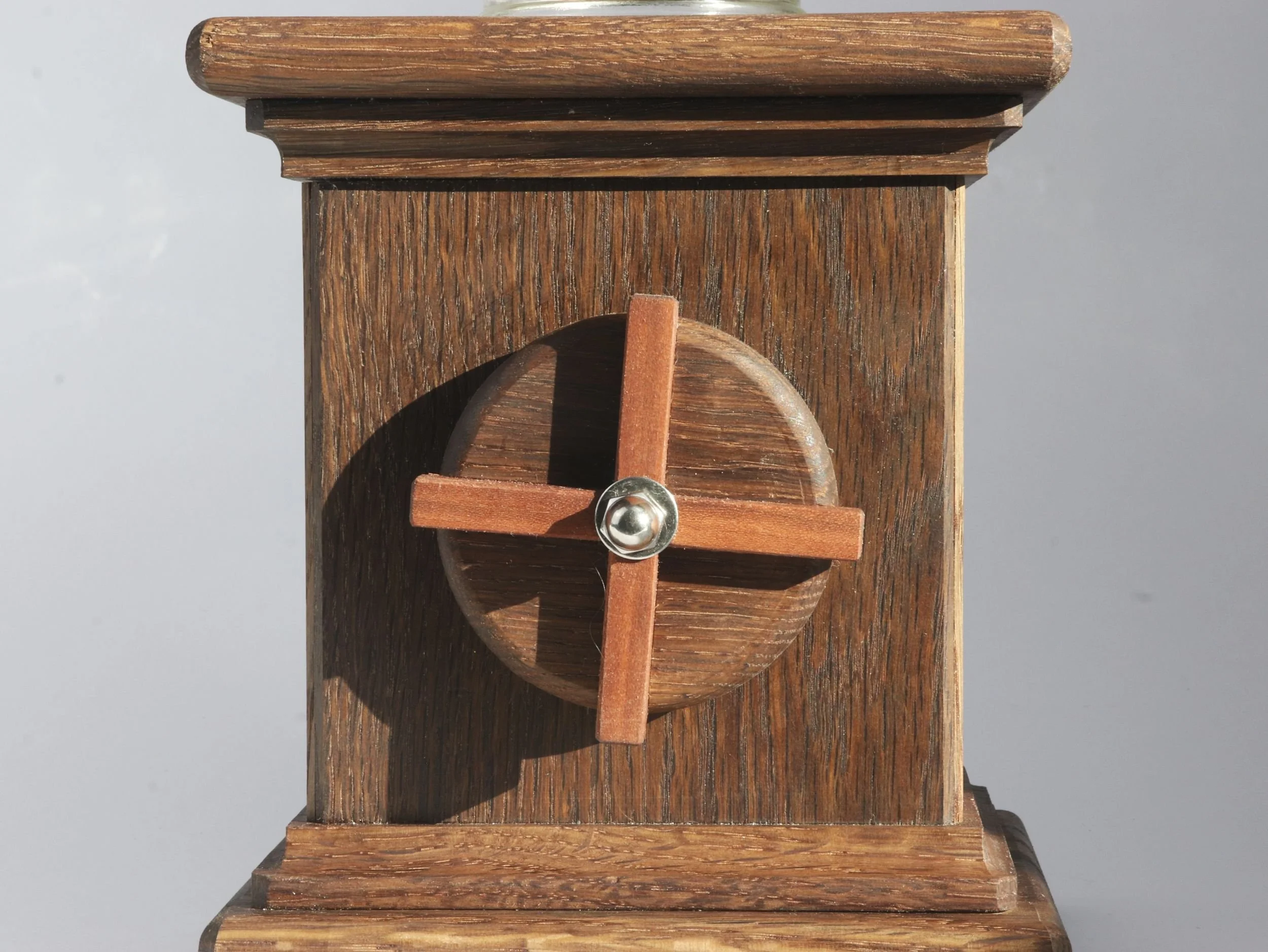 Close up of Brazilian cherry X inlay on candy dispenser hand crank with fumed oak contrast