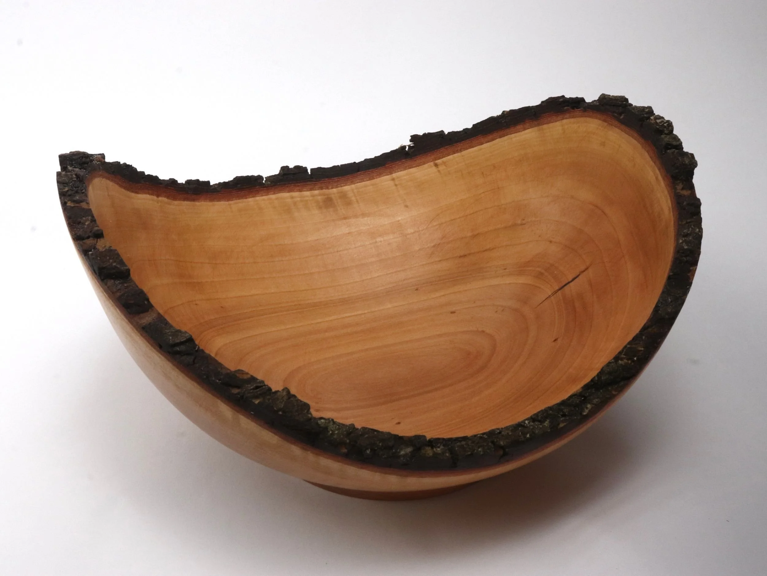 Angled view of cherry serving bowl interior showing 3 inch depth and smooth food-safe finish with natural grain