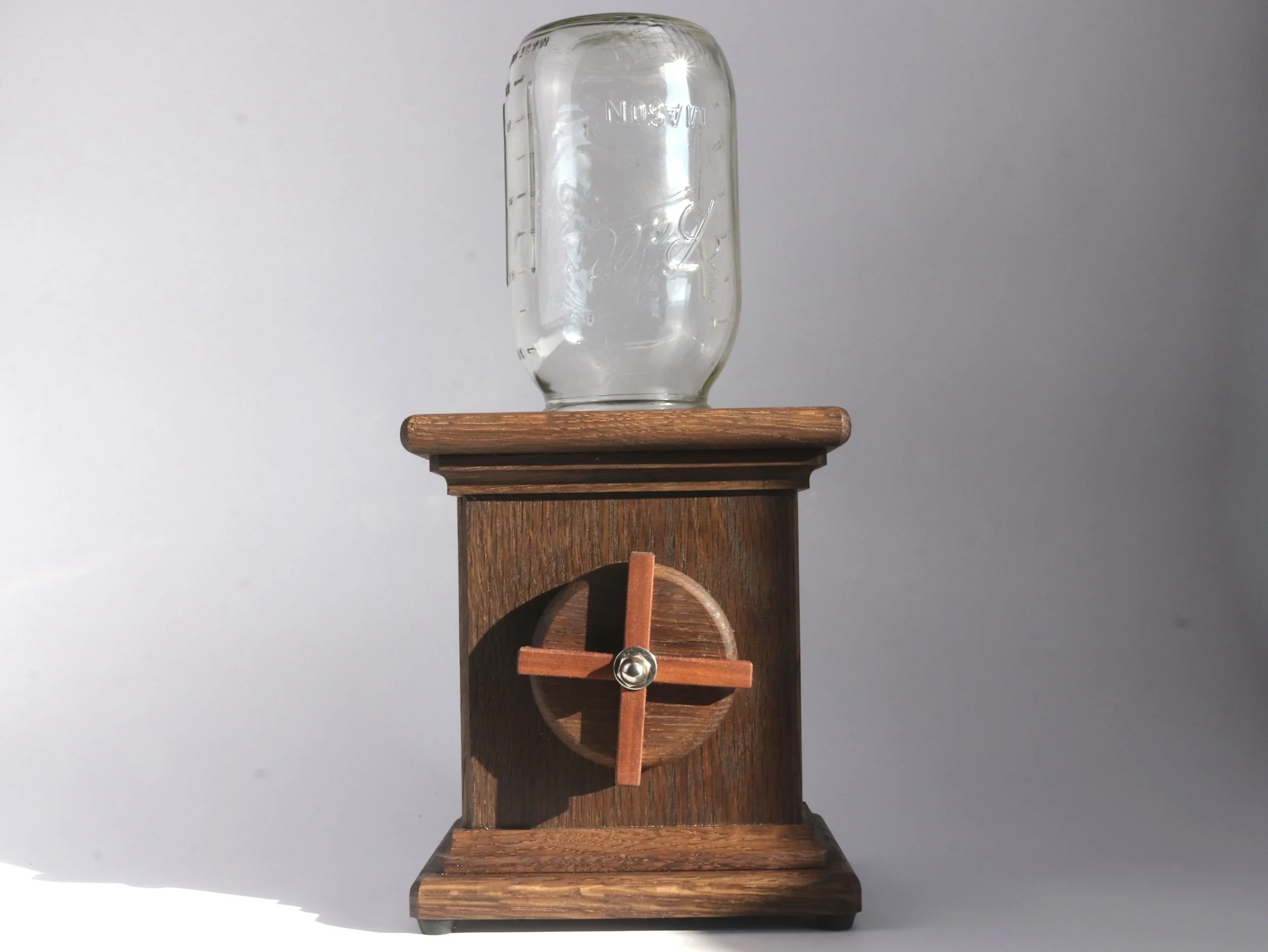 Handmade fumed oak candy dispenser with Brazilian cherry X detail on hand crank full view