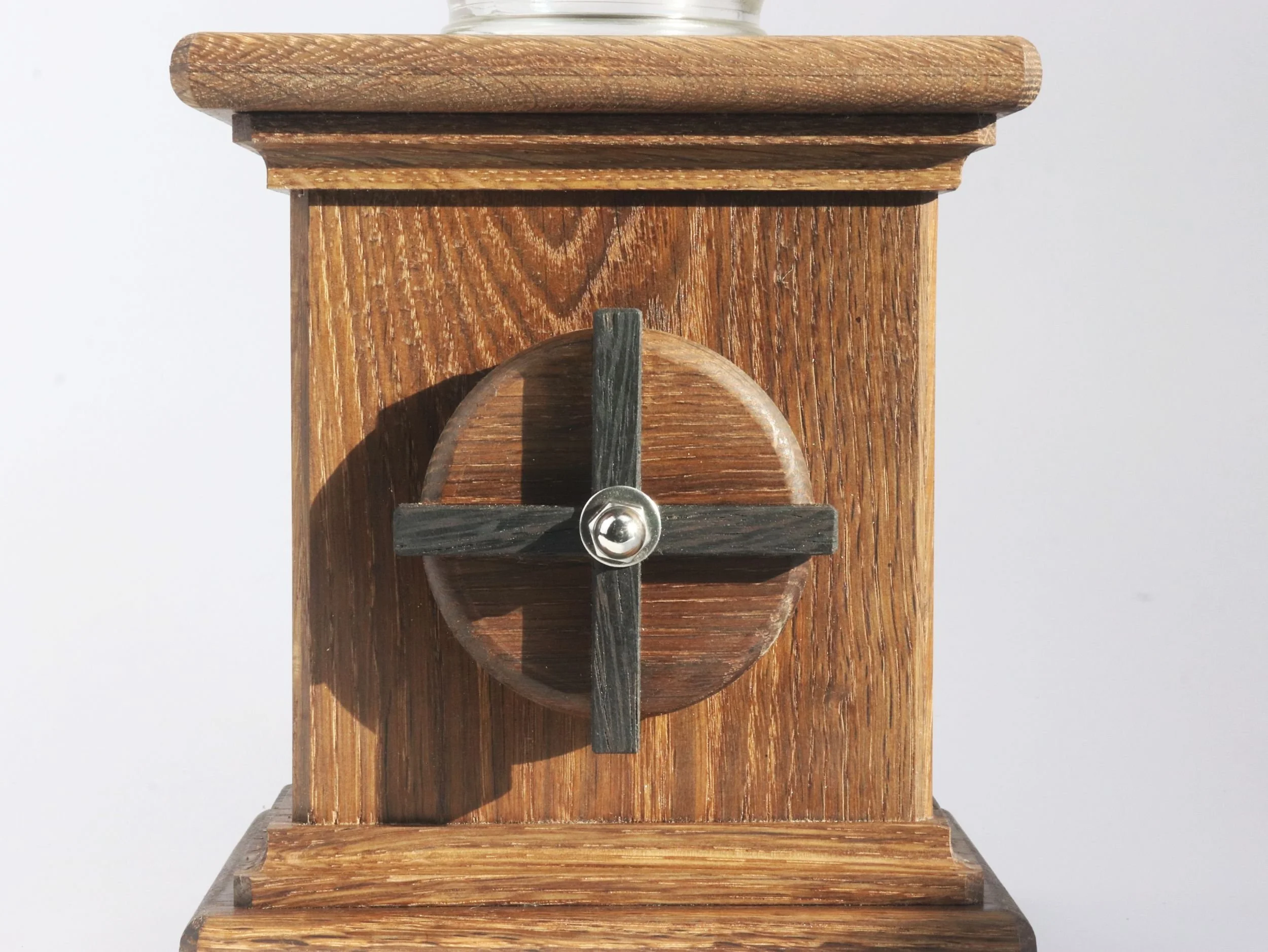 Close up of dark wenge X detail on hand crank showing dramatic contrast with fumed oak base