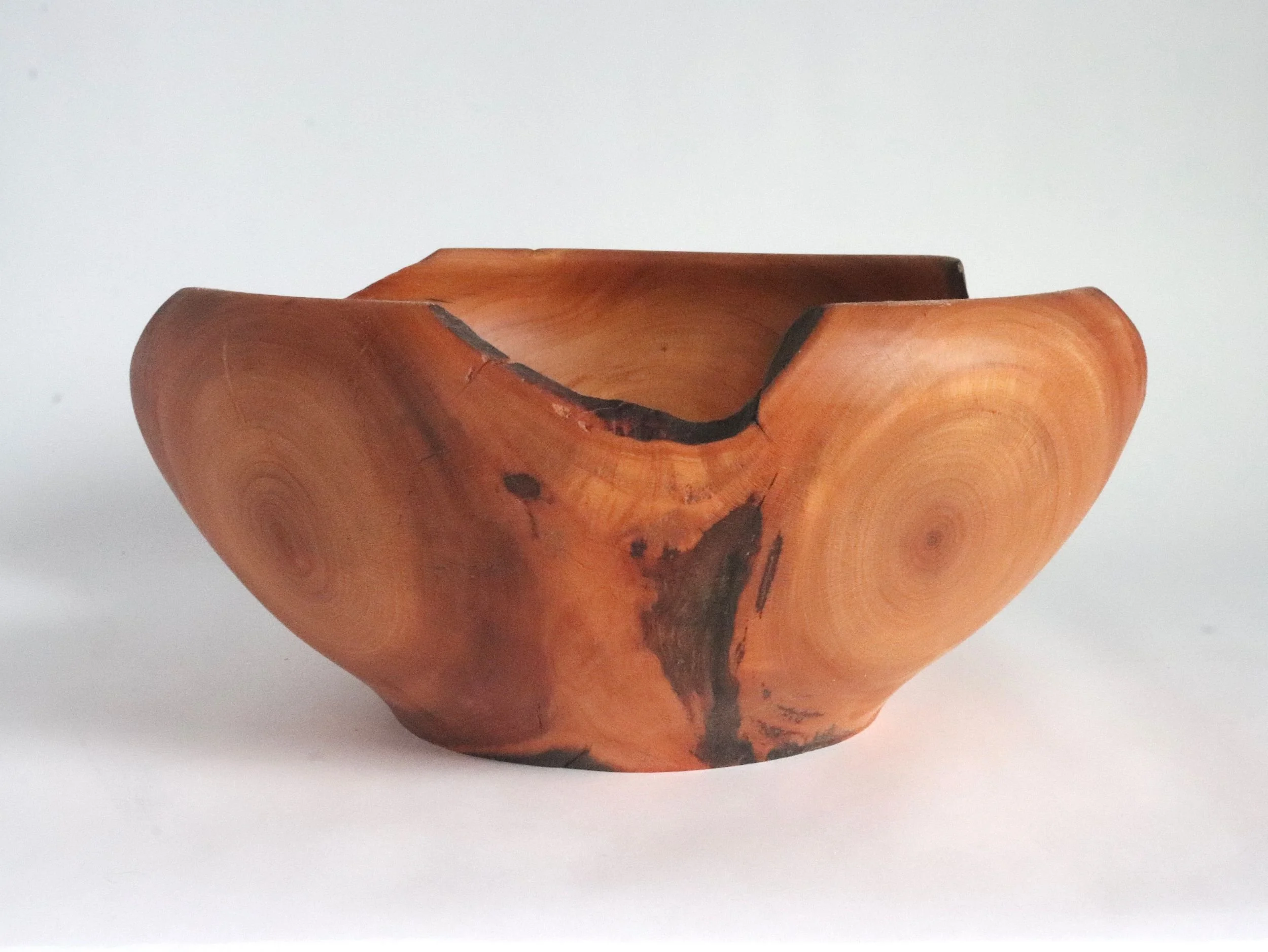 Legacy Collection cherry bowl side profile featuring distinctive feathering grain where two tree branches merged, with organic live edge details