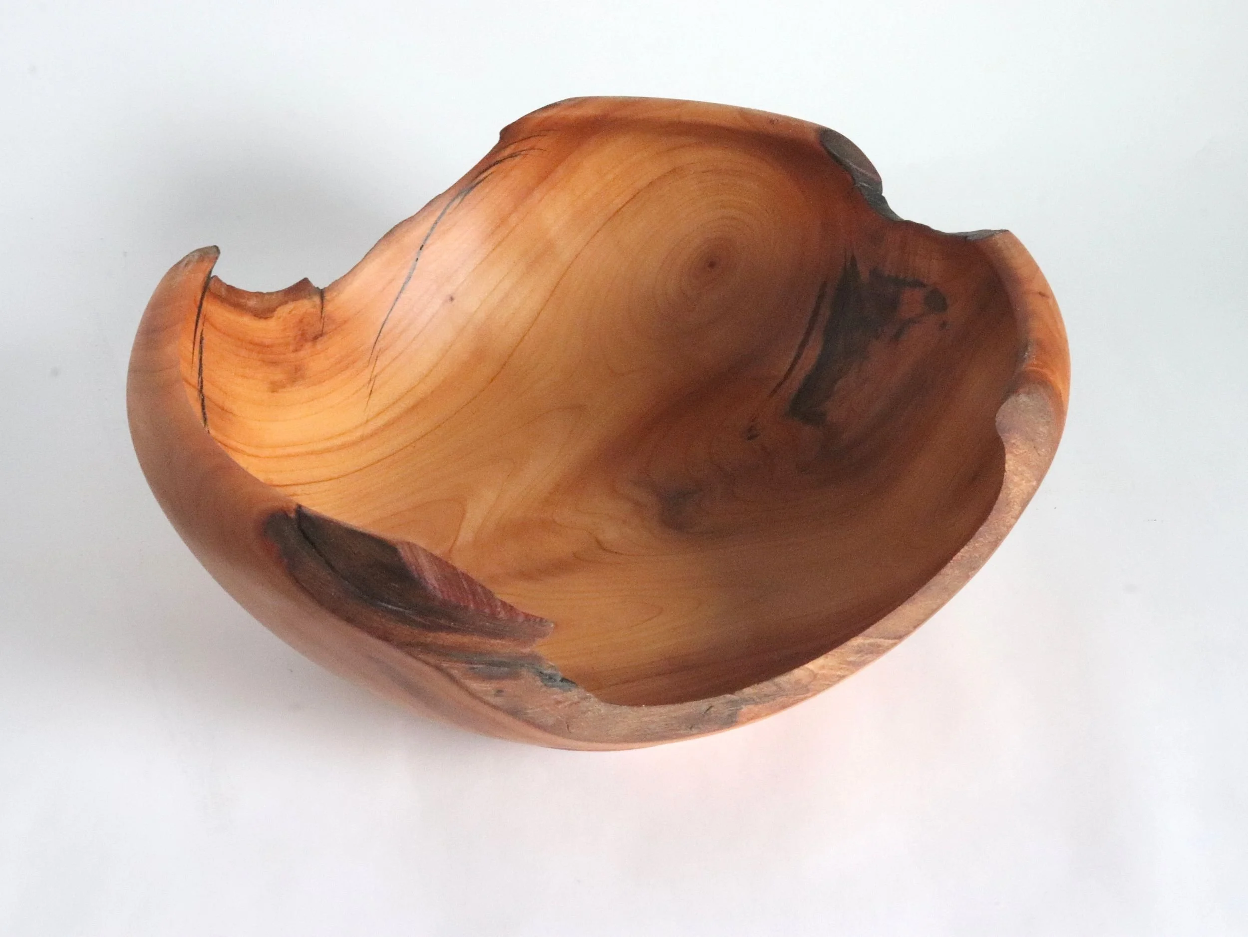 nterior view of handcrafted cherry wood bowl from elevated angle, showing deep 4.75" interior, grain feathering patterns, and food-safe Odies oil finish