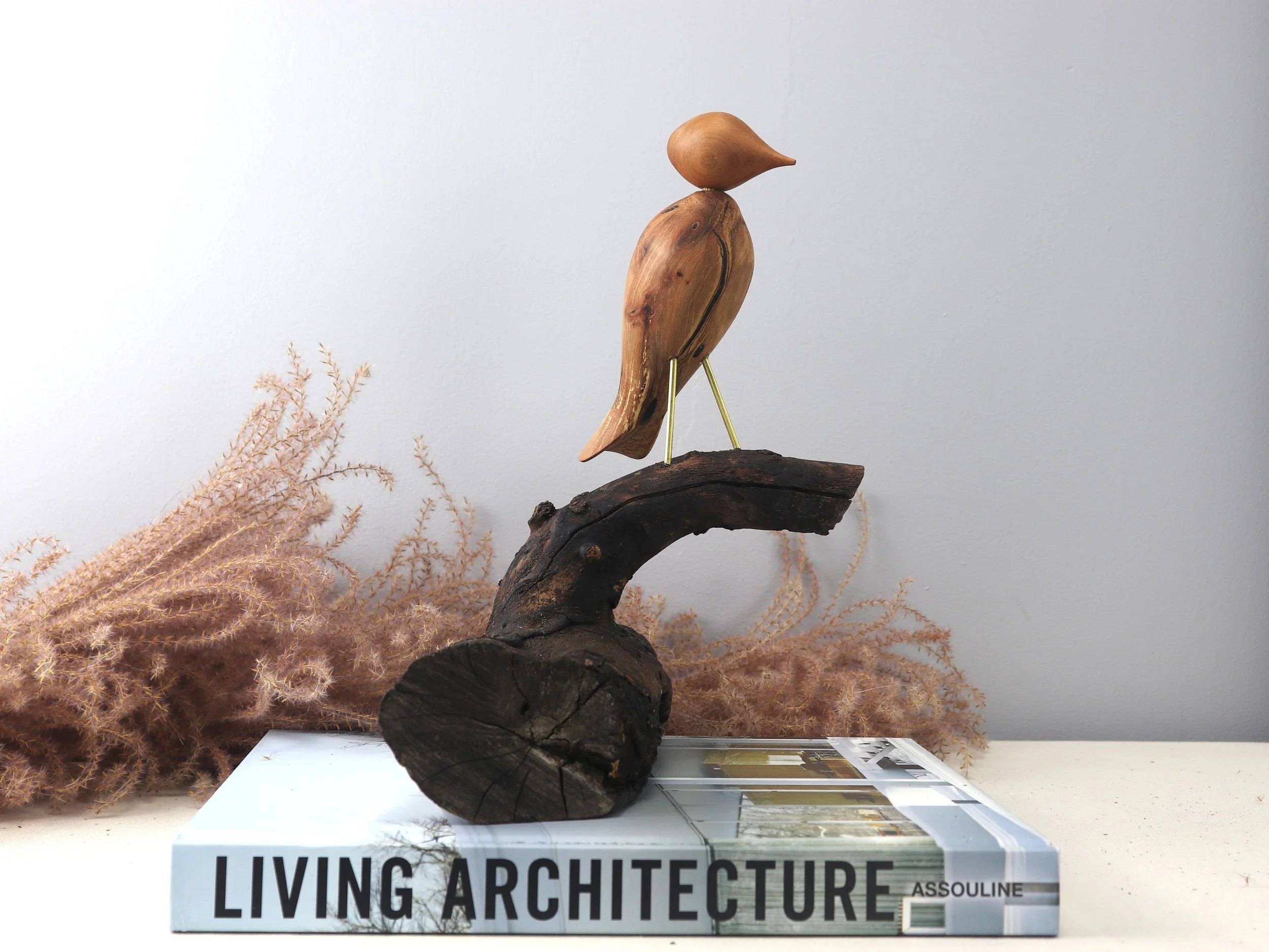 Handmade Contemplative Bird dogwood sculpture with carved bird on horizontal log branch, front angle view