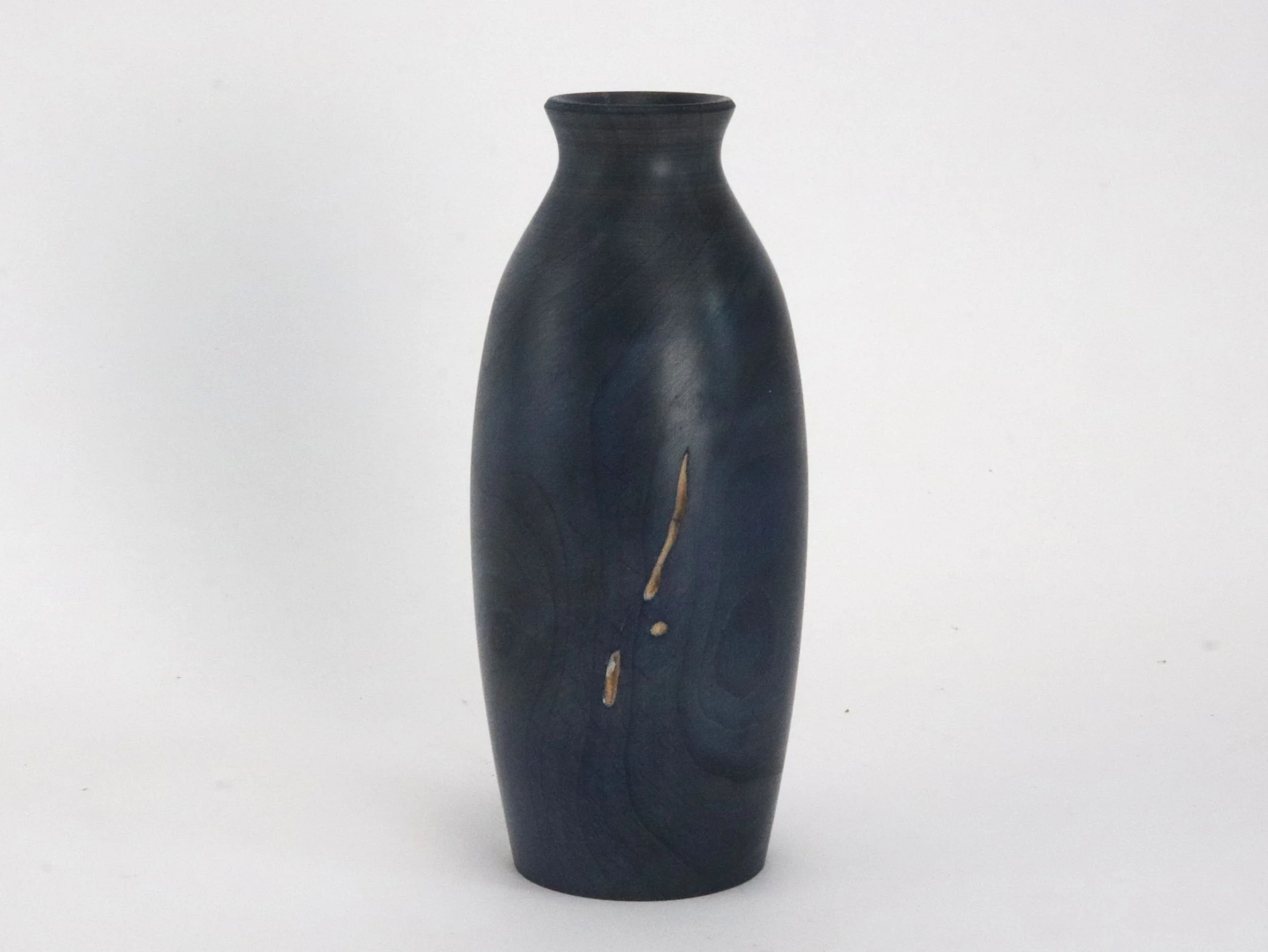 Close up of handmade wood vase showing natural ambrosia beetle tracks in navy stained maple