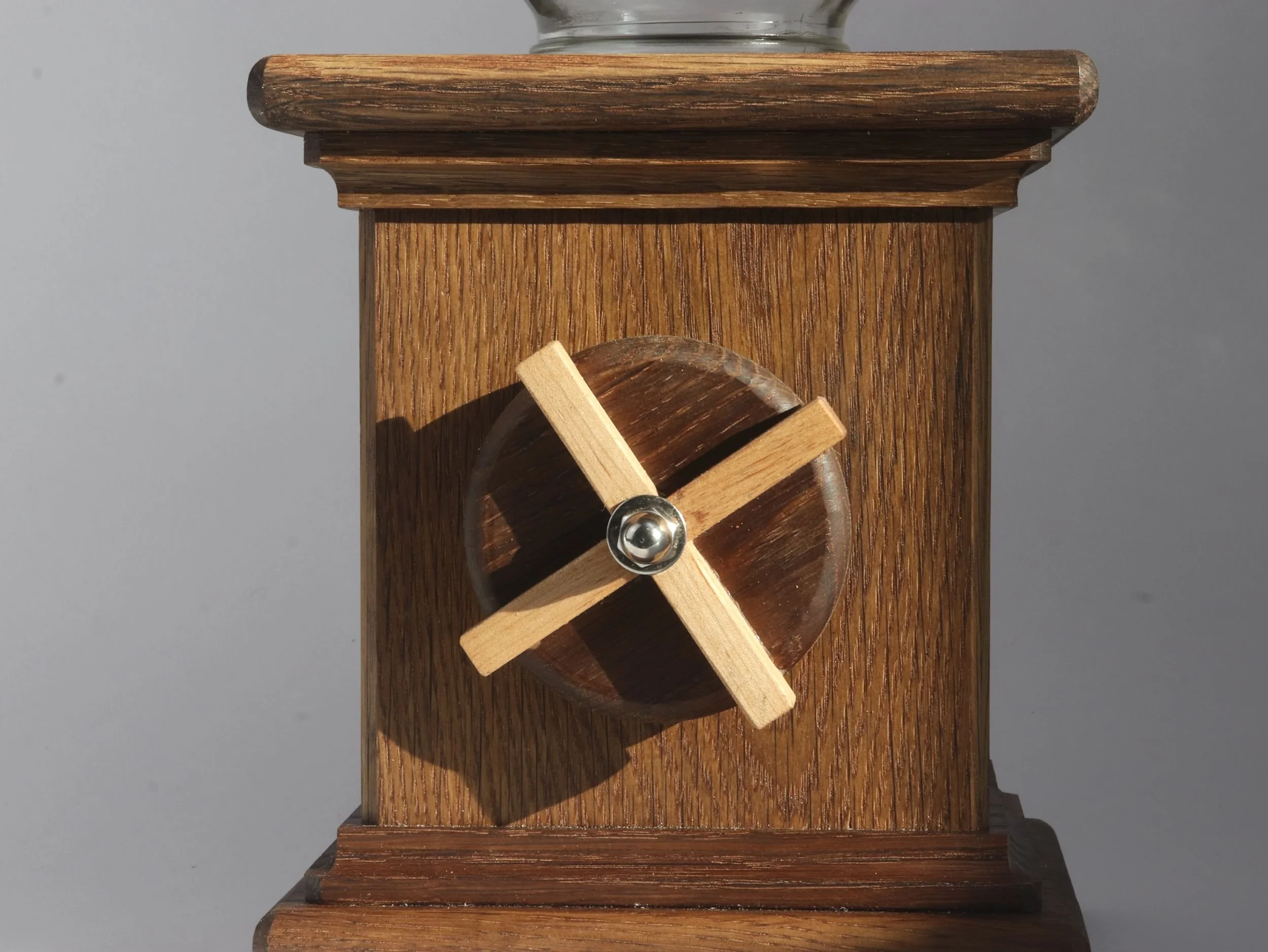 Detail shot of maple X inlay contrasting with chocolate brown fumed oak on candy dispenser crank