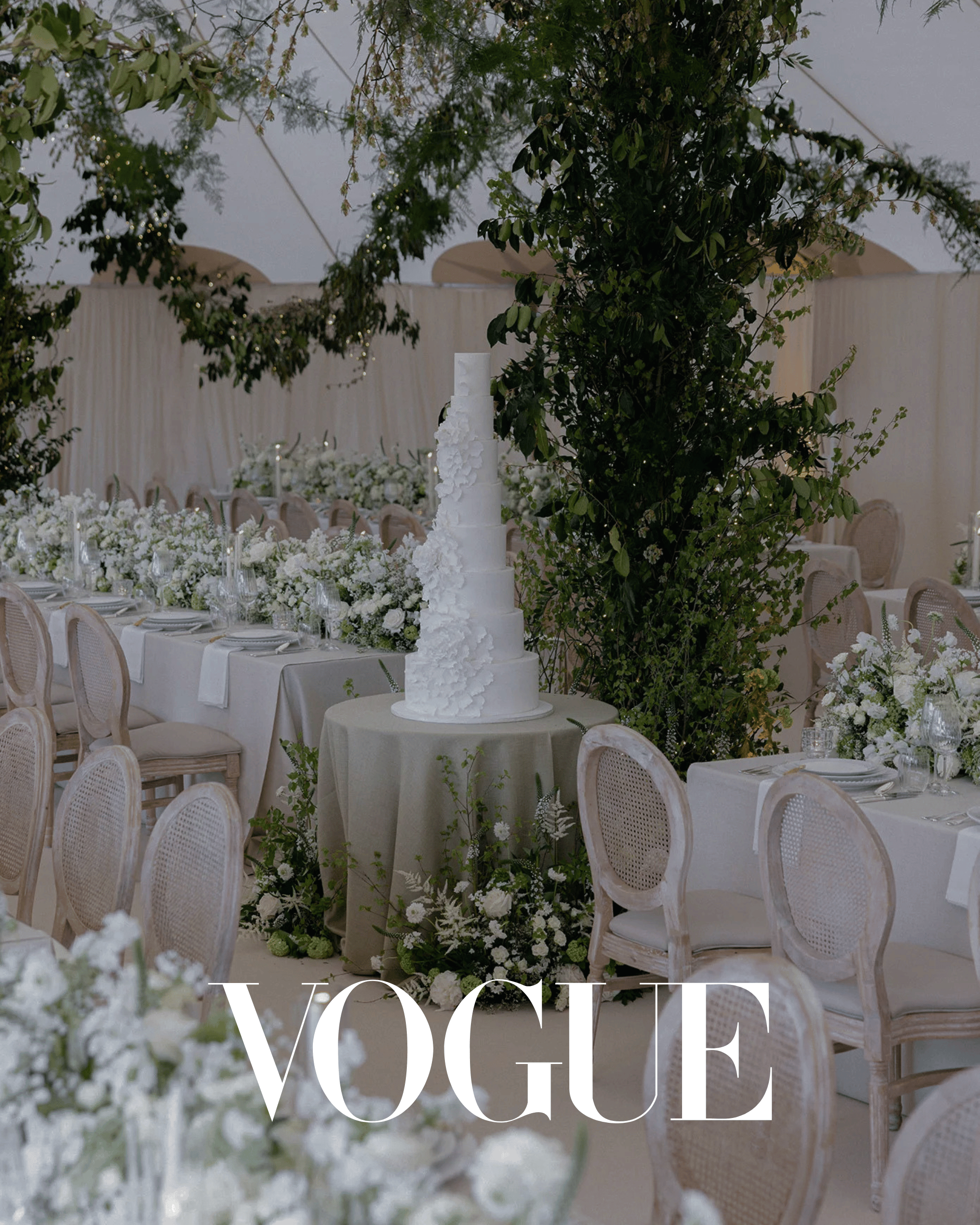 Luxury wedding reception with Wedhead French-style cane back chairs, elegant table settings and white floral arrangements