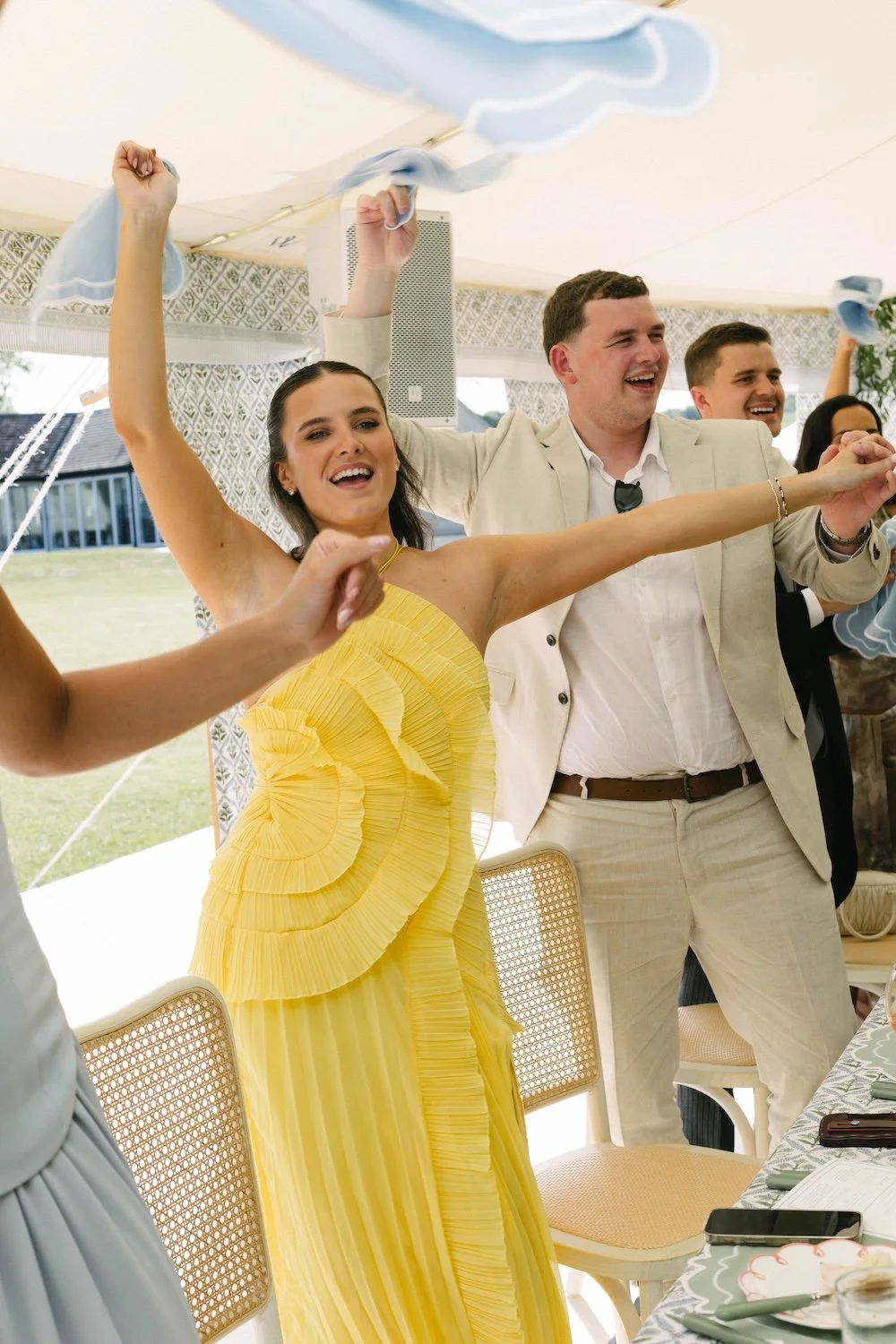 a wedding featuring pastel colours, natural materials such as cane and rattan with an outdoor dancefloor