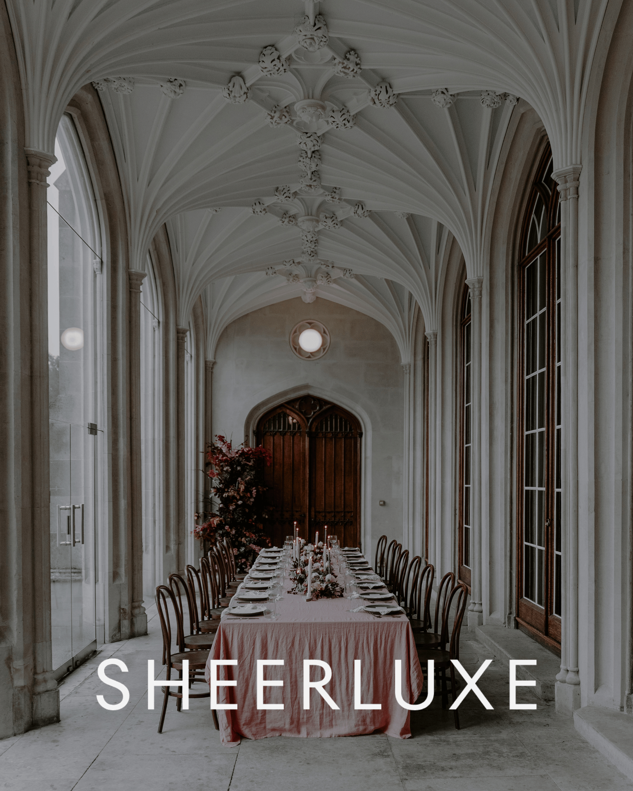 Luxury wedding reception with Wedhead walnut bentwood chairs, long banquet table and elegant floral styling in a historic venue