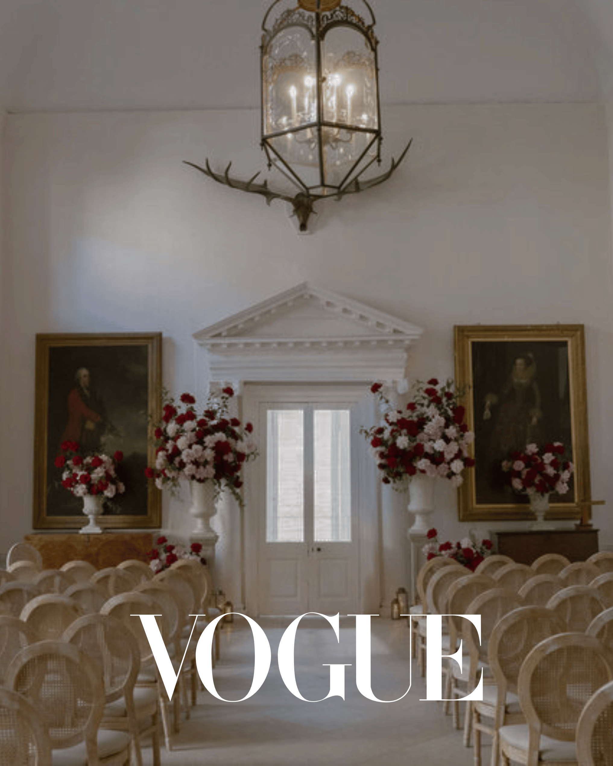 Elegant indoor wedding ceremony featuring Wedhead French-style cane back chairs and romantic red and pink floral arrangements