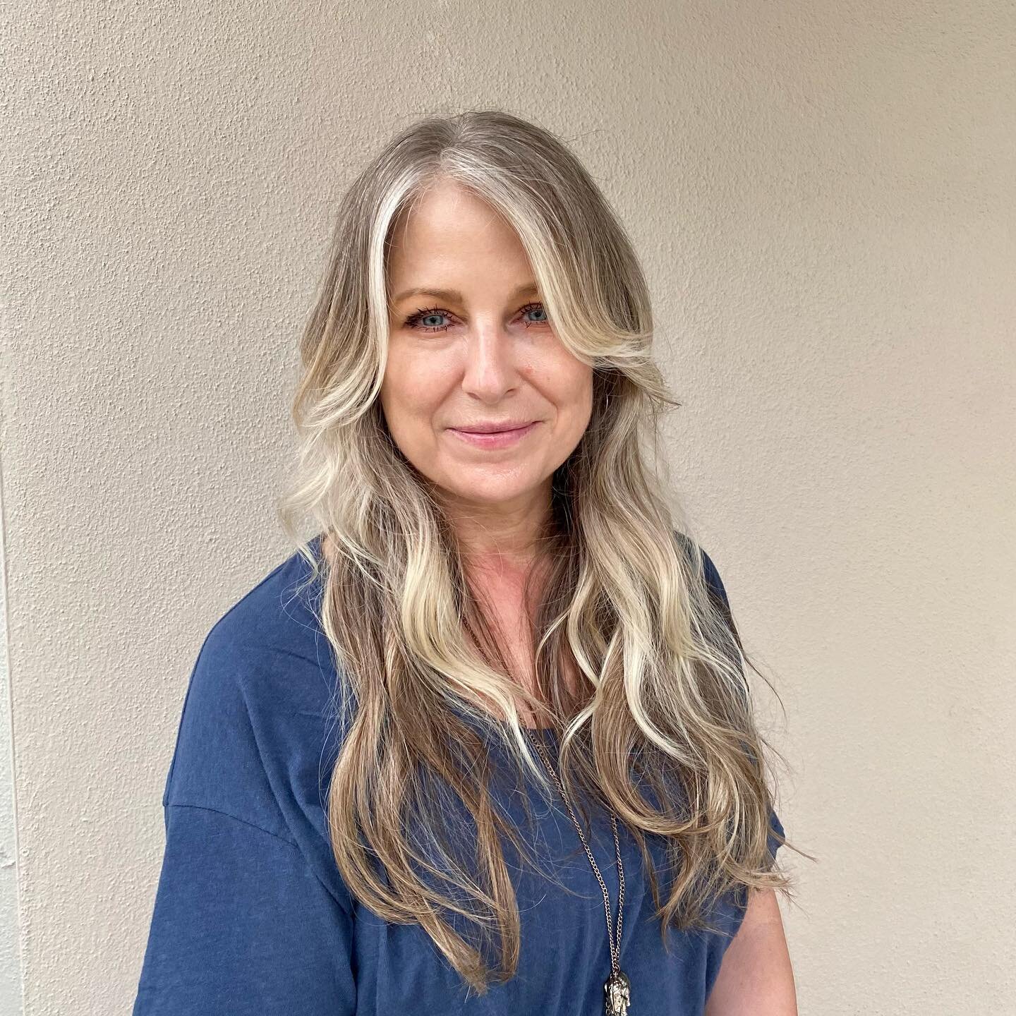 Kimmi achieved this look by adding lowlights to Christine&rsquo;s beautiful natural gray. Swipe to the end to see her natural color! When growing out your gray hair, you may find that the white hair can wash you out so adding depth with lowlights can