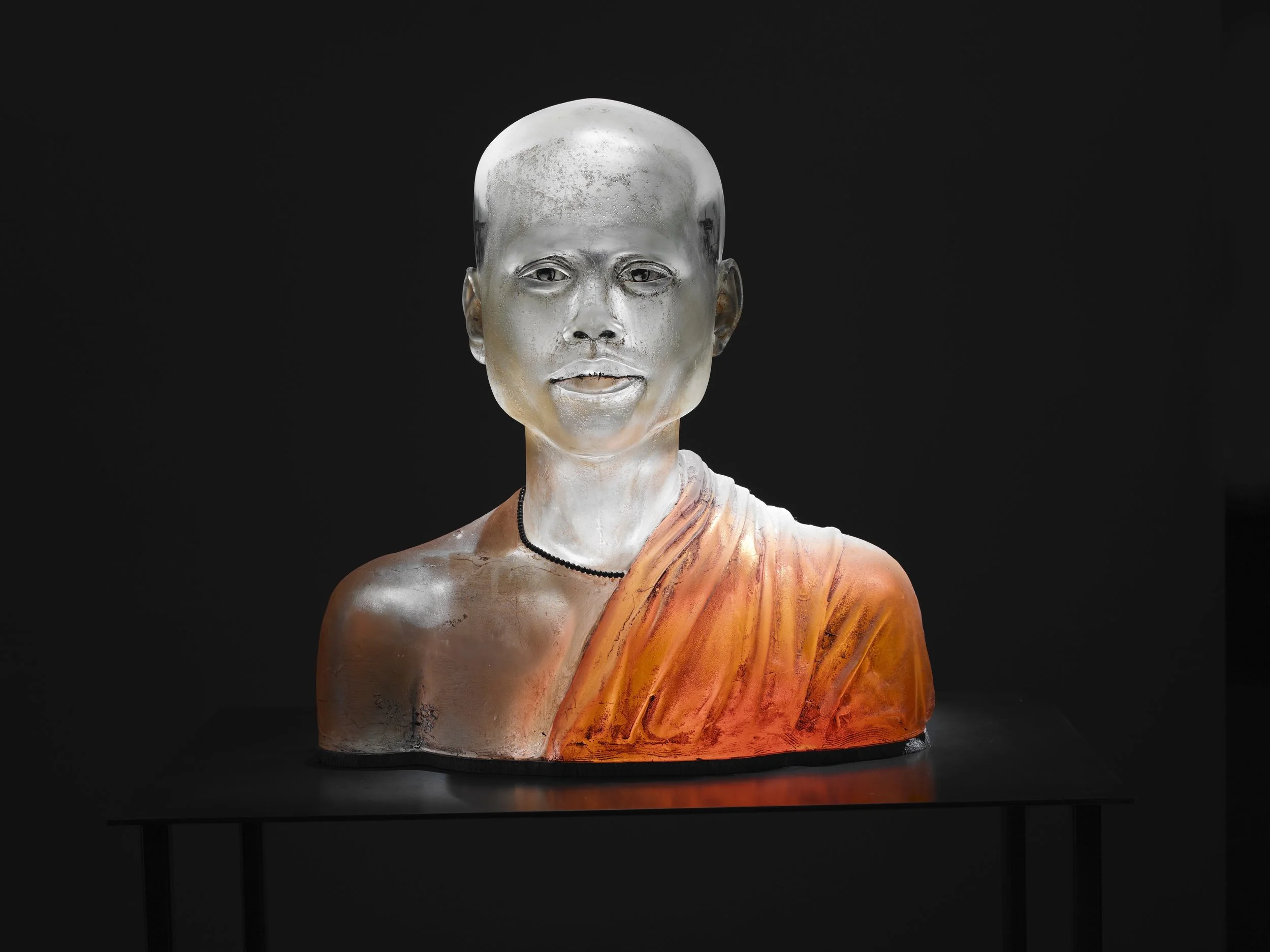 Projections in Tun Yee | Mold Blown Glass, Concrete, Mixed Media | 25.5" H x 24.5" W x 13" D | 2010
Blown glass figure, concrete robe, internal projector plays video taken in conflict zones in Burma. These images play inside the visual cortex and ar