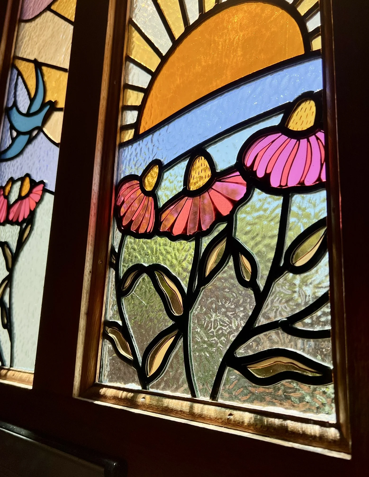 maximalist stained glass front door set featuring swallows, a sunset and fuchsia pink cone flowers
