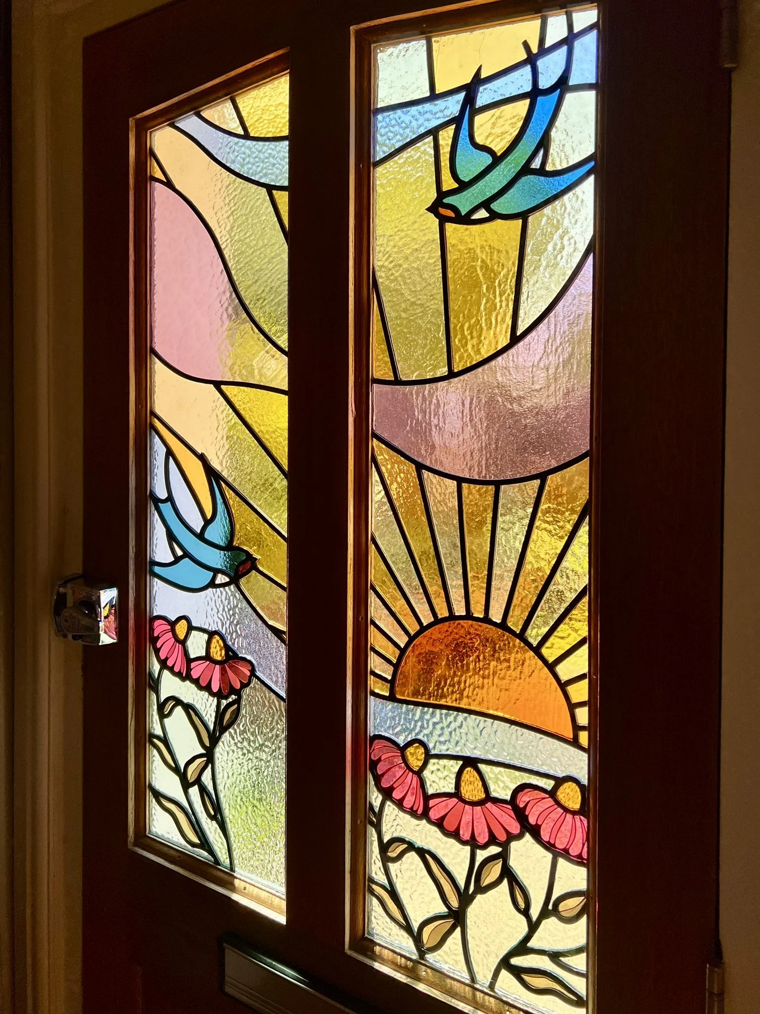 maximalist stained glass front door set featuring swallows, a sunset and fuchsia pink cone flowers